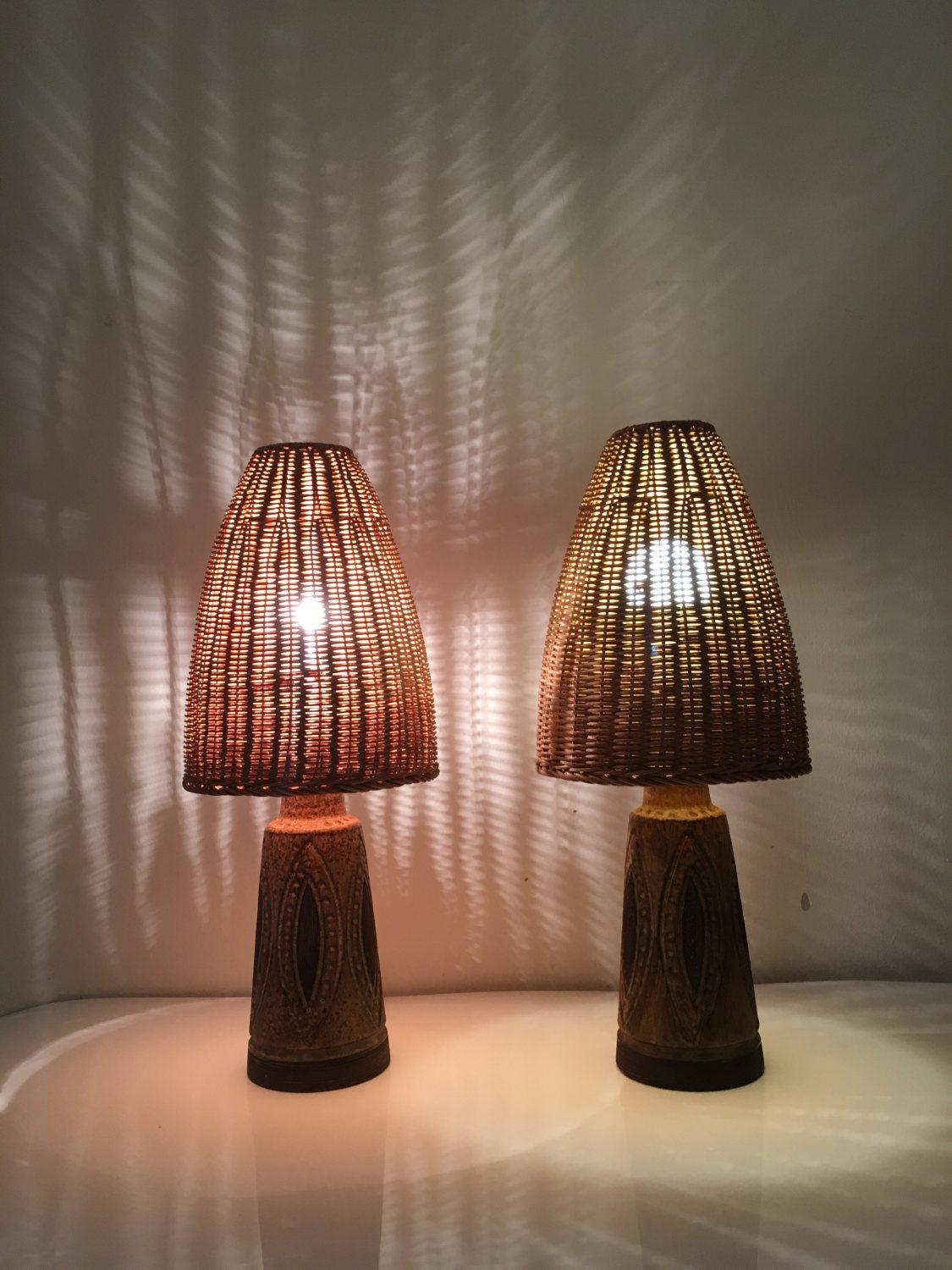 Pair of special ceramic table lamps, with original wicker lamp shade from Denmark 1970s. The body of this pair of table lamps is brown and black glazed ceramic with vintage shapes engraved on it. The lampshade is an original woven rattan shade in