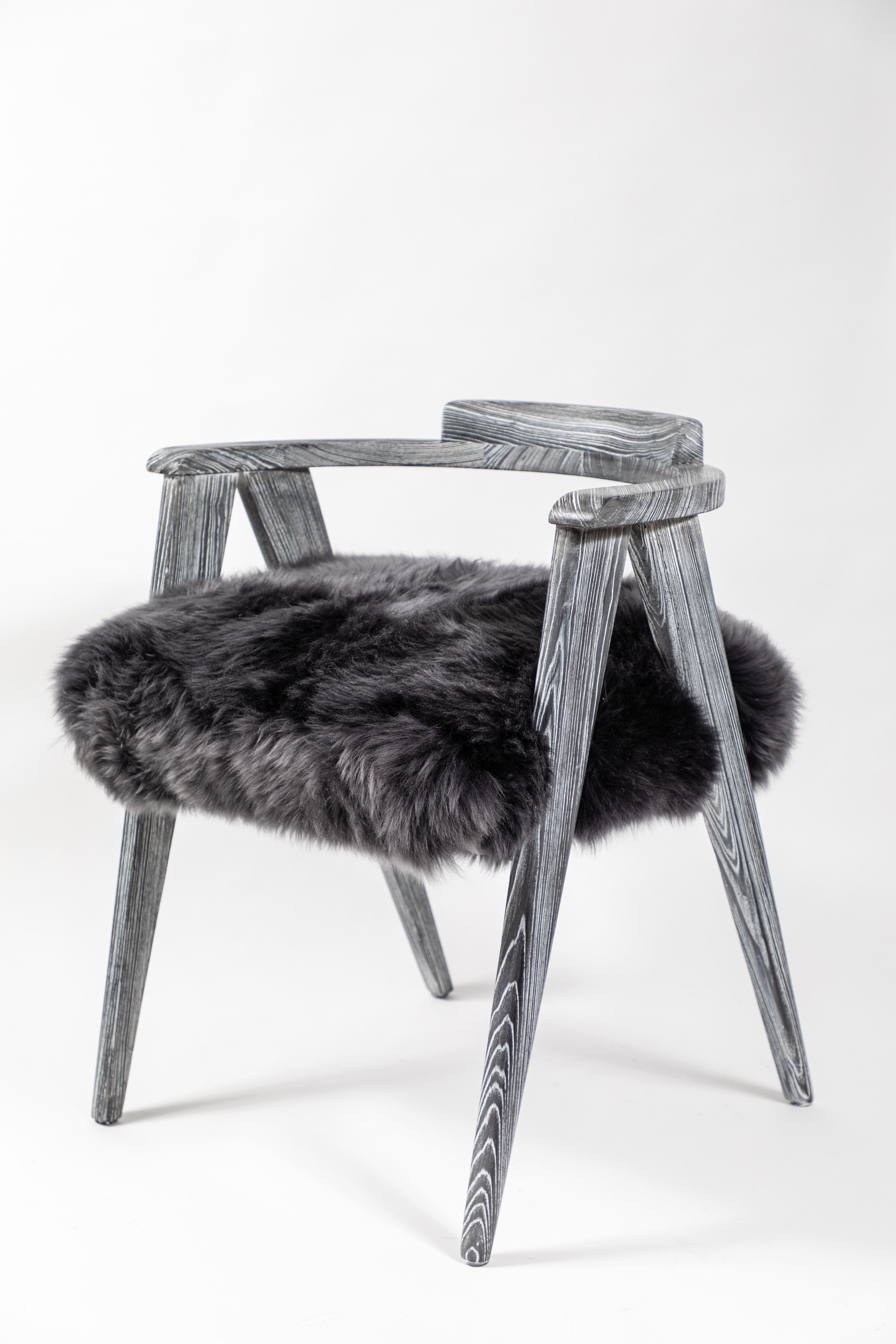 Stylish pair of midcentury chairs with round backs and scissor style legs. Newly refinished in a gray ceruse, the chairs have been upholstered in gray sheepskin fur.