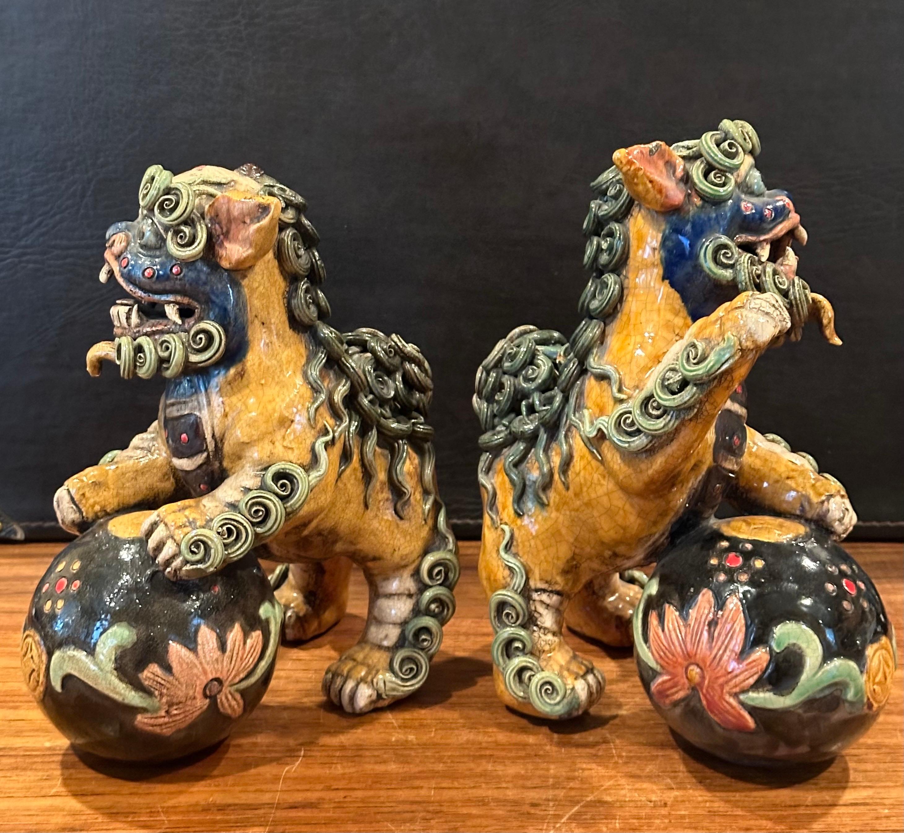 Hand-Crafted Pair of Mid-Century Chinese Ceramic Polychrome Foo Dogs For Sale