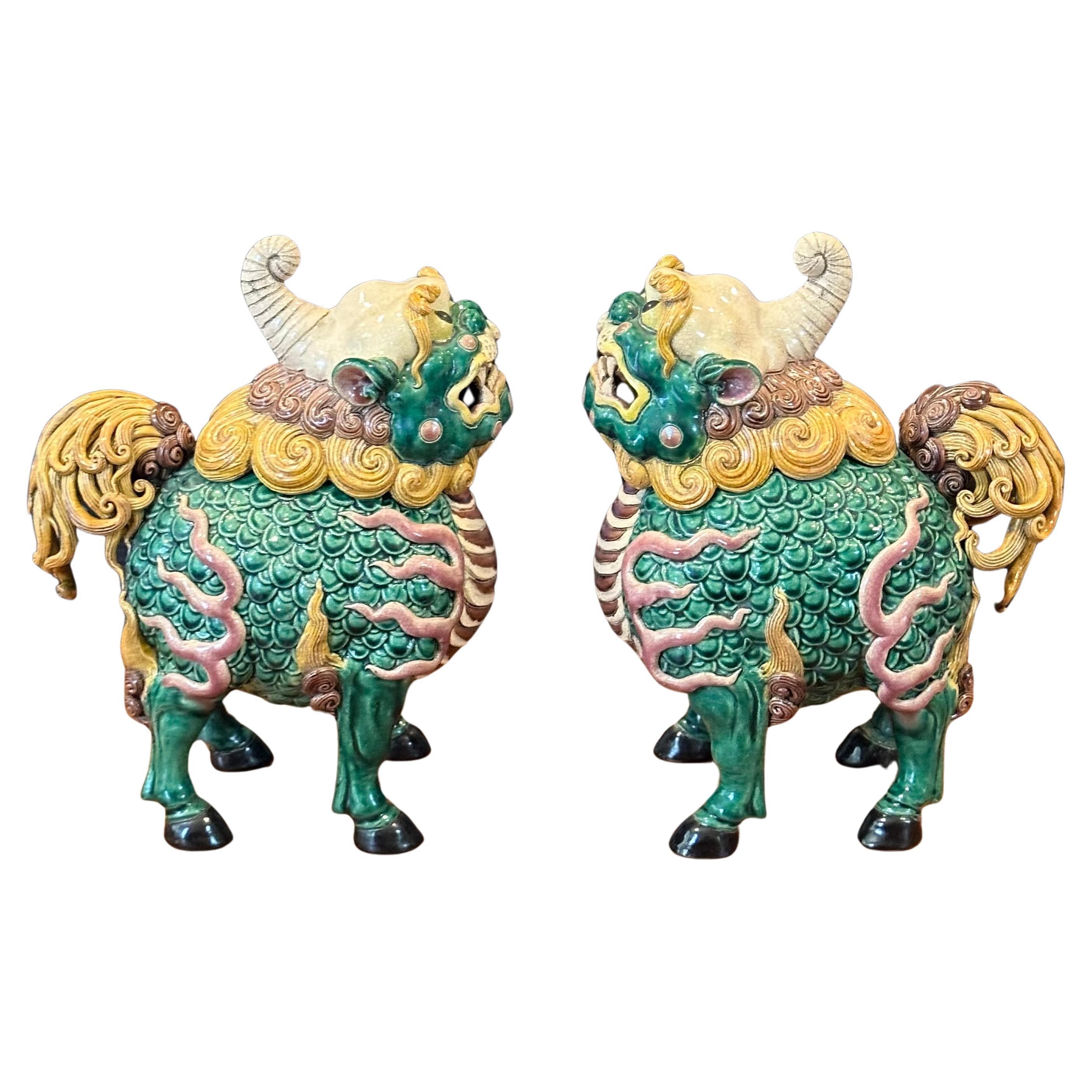 Fantastic pair of mid-century Chinese ceramic polychrome incense censer foo dogs, circa 1970s. Great detail and a beautiful color combination of yellow, green and brown; the pair measure 14