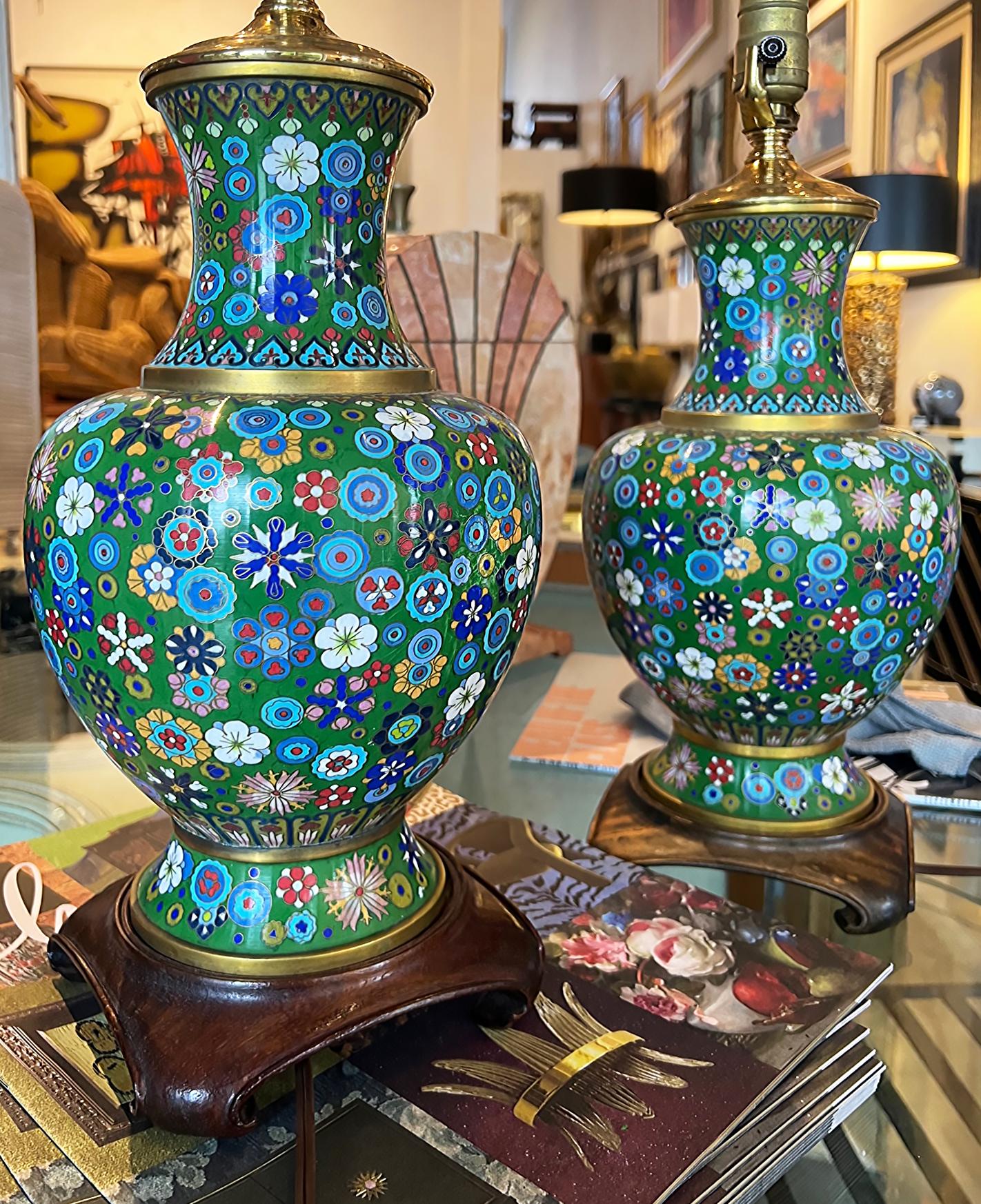 Pair of Mid-century Chinese Cloisonne Urns Table Lamps on Wood Bases

Offered for sale is a lovely colorful pair of Chinese Cloisonne urns that have been fitted into table lamps and mounted upon wood bases. The Cloisonne urns are in very good
