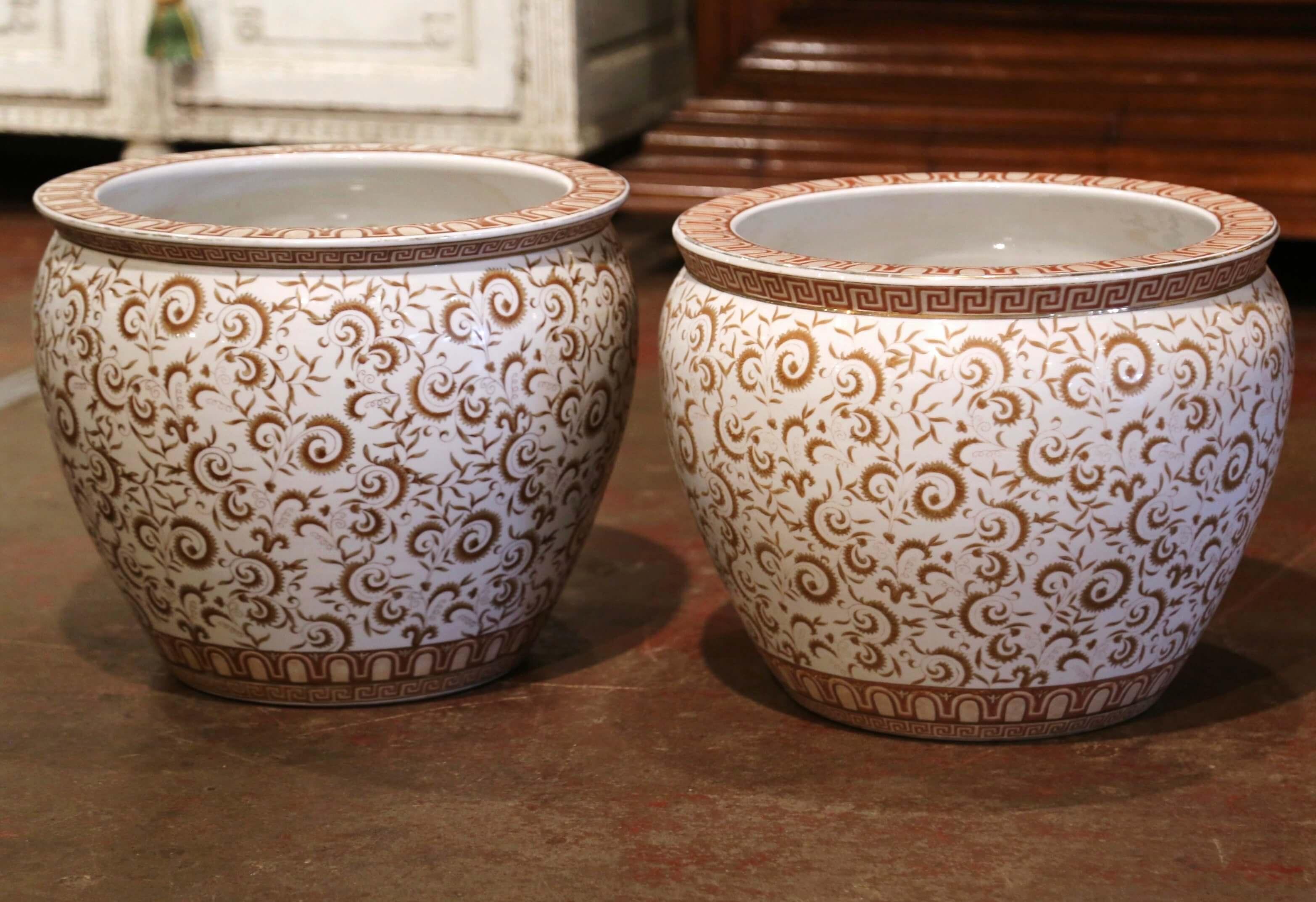 These elegant and colorful vintage fishbowls were created in China, circa 1970. Round in shape, each large exotic porcelain planter features Classic foliage motifs throughout. The ceramic vases are painted on the inside as well with a traditional