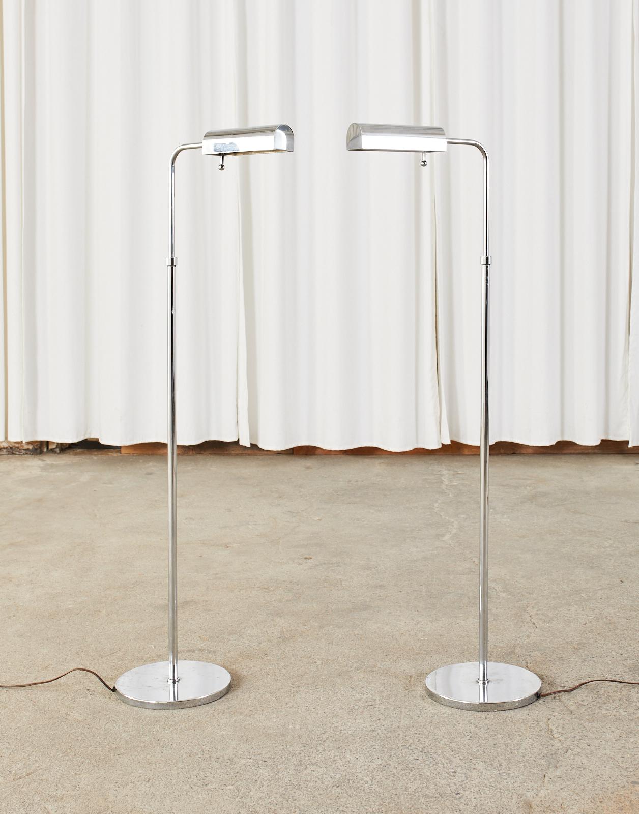 Gorgeous pair of mid-century modern height adjustable pharmacy floor lamps featuring a thick nickel chrome finish. The weighted lamps adjust from 44 inches to an amazing 58 inches high with a swivel and tilt head. The light has an adjustable dimmer