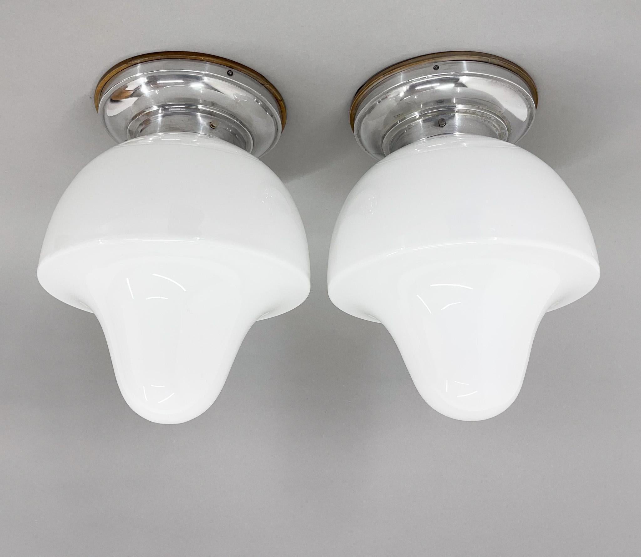 Set of two vintage chrome and milk glass ceiling lights produced in former Czechoslovakia in the 1960's. The lights have been restored. 
Bulbs: 2x 1 E26-E27. 
US wiring compatible.