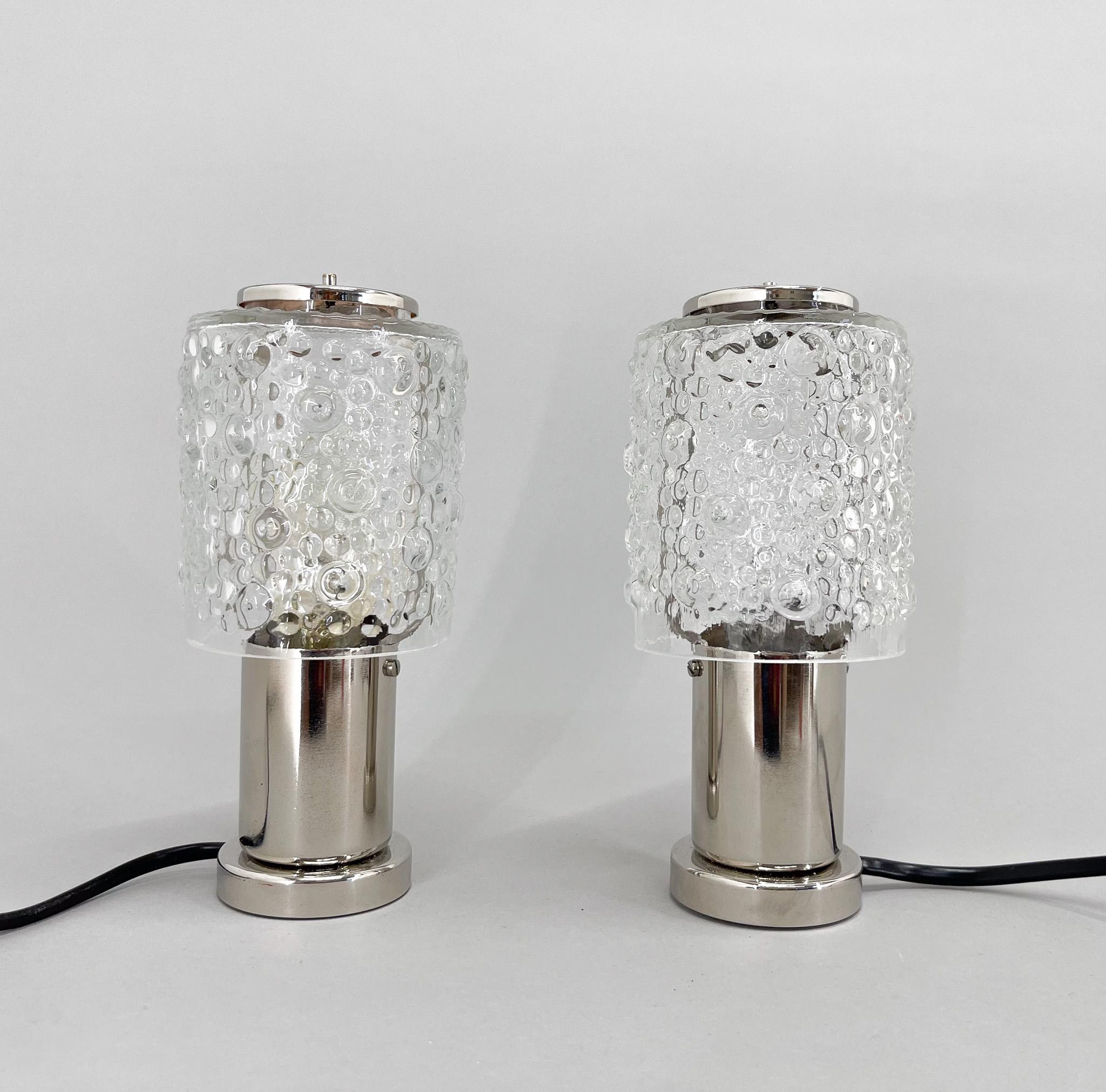 Set of two small table or bedside lamps by famous Kamenicky Senov Glassworks. Produced in former Czechoslovakia in the 1960's. 
The lamps were restored and rewired. 
Bulb: 2x1 E14-E15 bulbs. US plug adapter included.