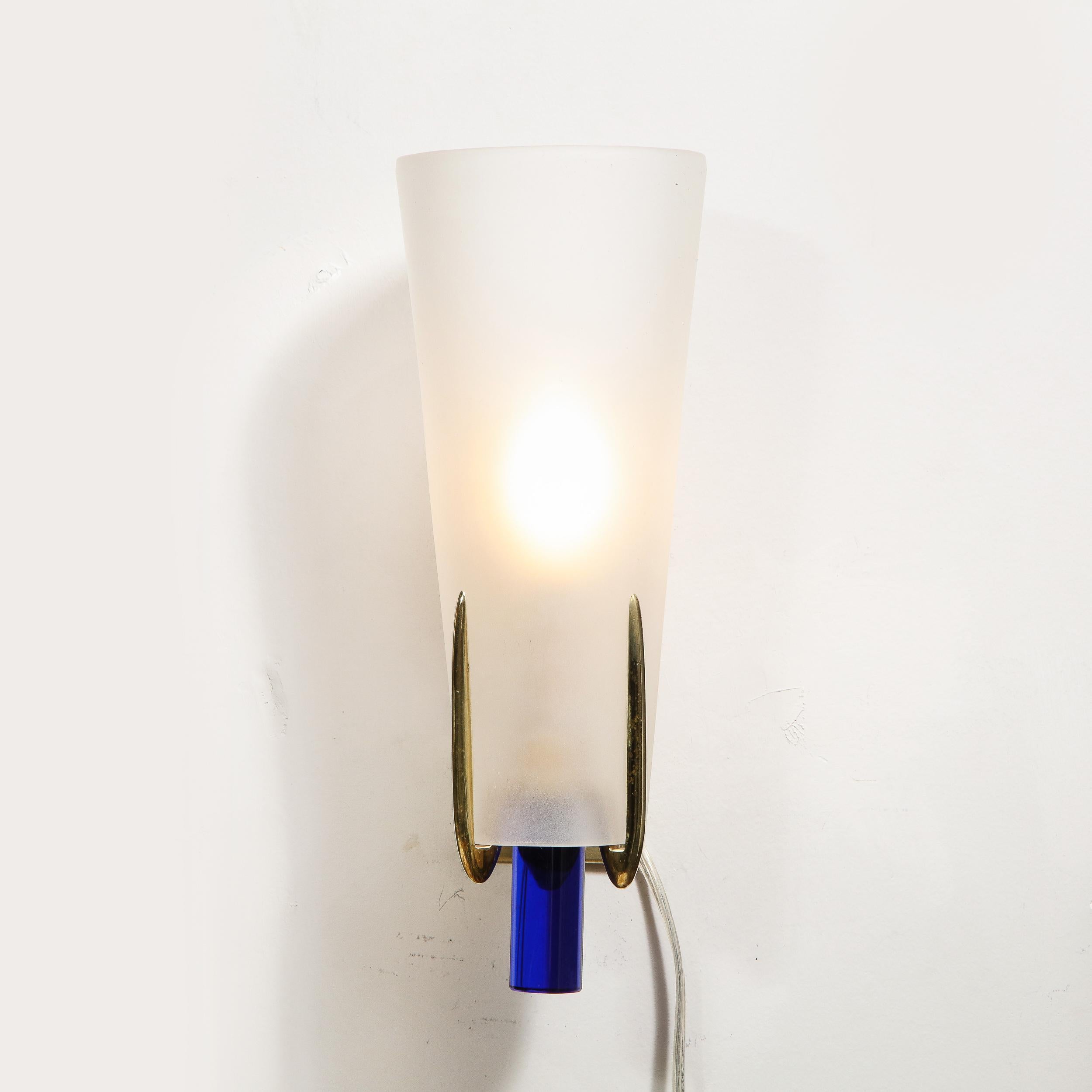 Realized in the manner of Gio Ponti, this sophisticated and graphic pair of sconces were created in Italy, circa 1960. They consist of conical frosted glass shades secured by polished brass tendril like supports that affix to a rectangular backplate