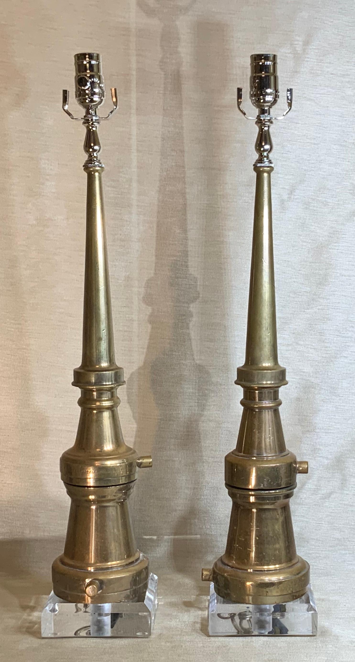 Funky pair of table lamps made of firefighting solid copper nozzle made by the “Samuel Eastman Company”, mounted on beveled Lucite base. Great decorative pair of lamps. Lampshades are not included.
Size of the lamps without the shades from the