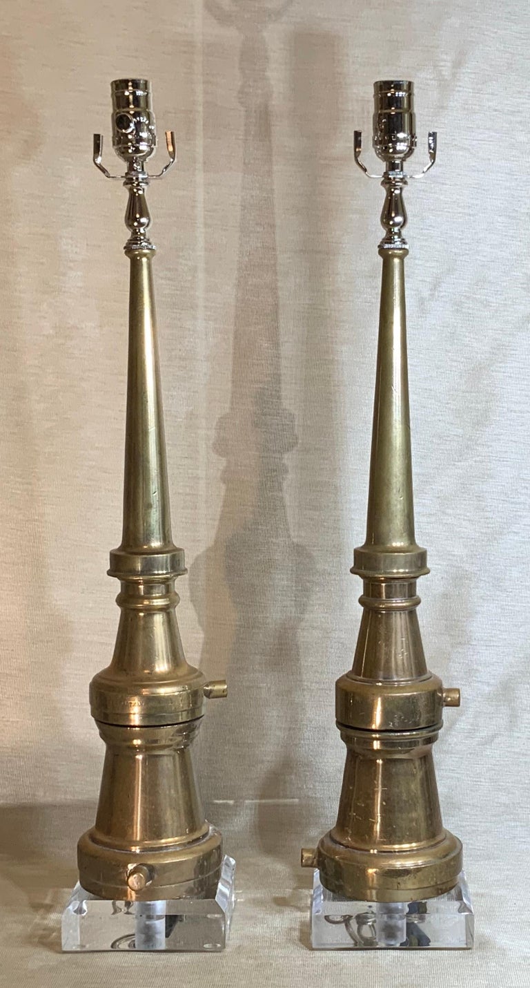 Funky pair of table lamps made of firefighting solid copper nozzle made by the “Samuel Eastman Company”, mounted on beveled Lucite base. Great decorative pair of lamps. Lampshades are not included.
Size of the lamps without the shades from the