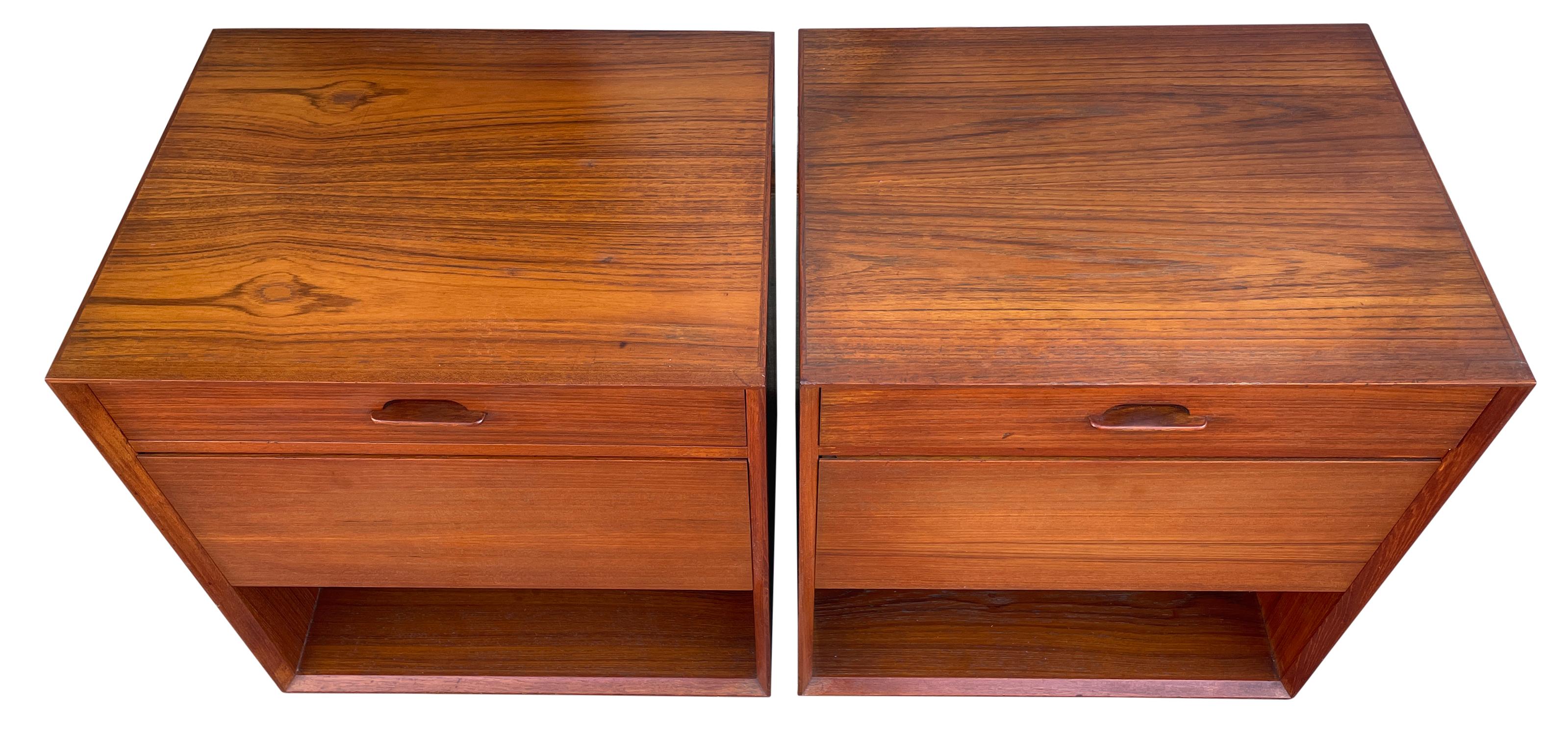 Pair of mid century Danish modem teak floating nightstands wall mount. Beautiful teak construction with 1 top narrow drawer with carved handle also has a large lower pull out drawer. Below the drawers is an open space for storage. Very stunning set