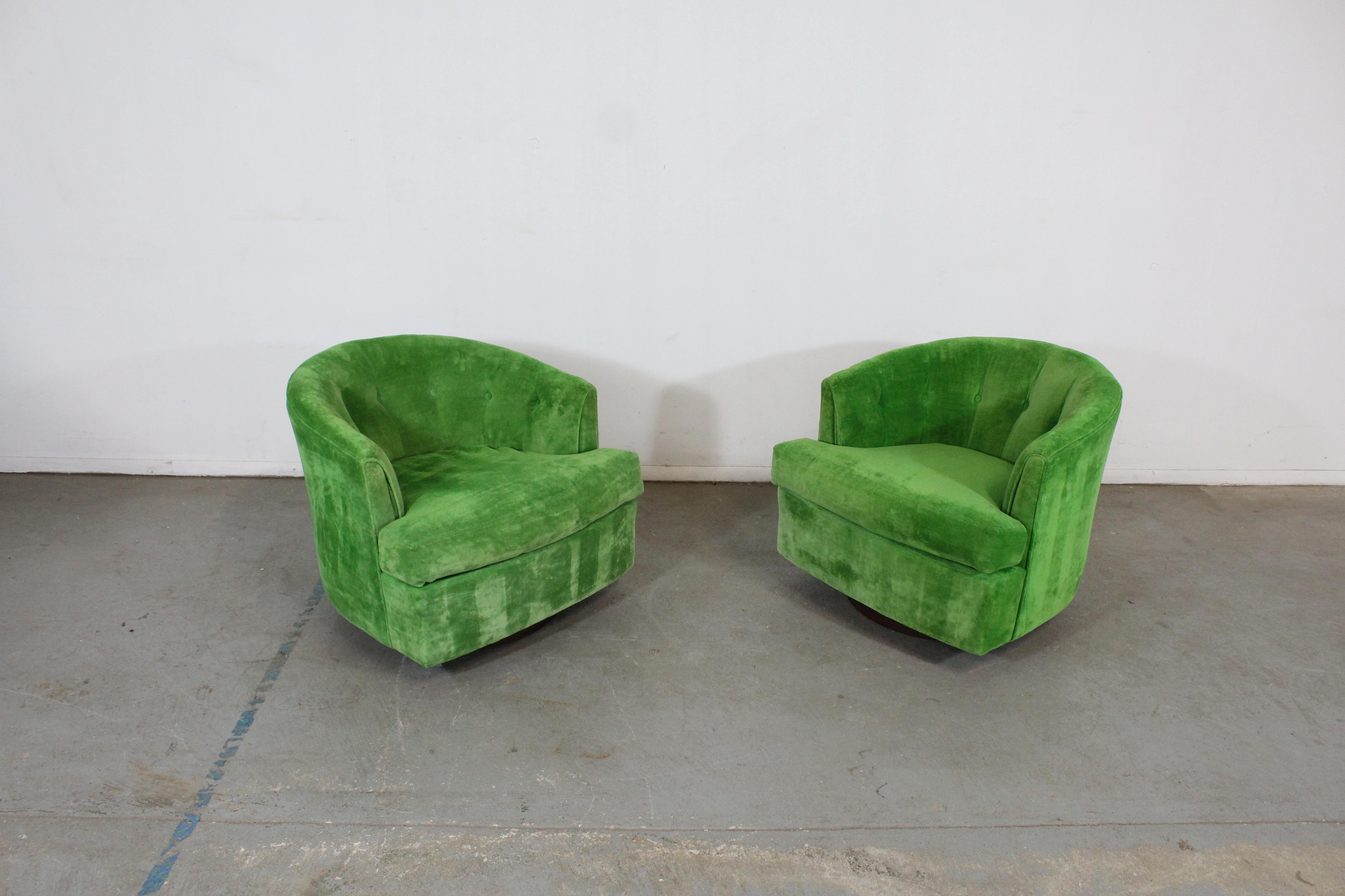 Pair of Mid-Century Modern Barrel Back Milo Baughman style Swivel Club Chairs

Offered is a pair of vintage Mid-Century Modern Milo Baughman style swivel chairs. These chairs have round backs and walnut bases. . They are in good condition. The