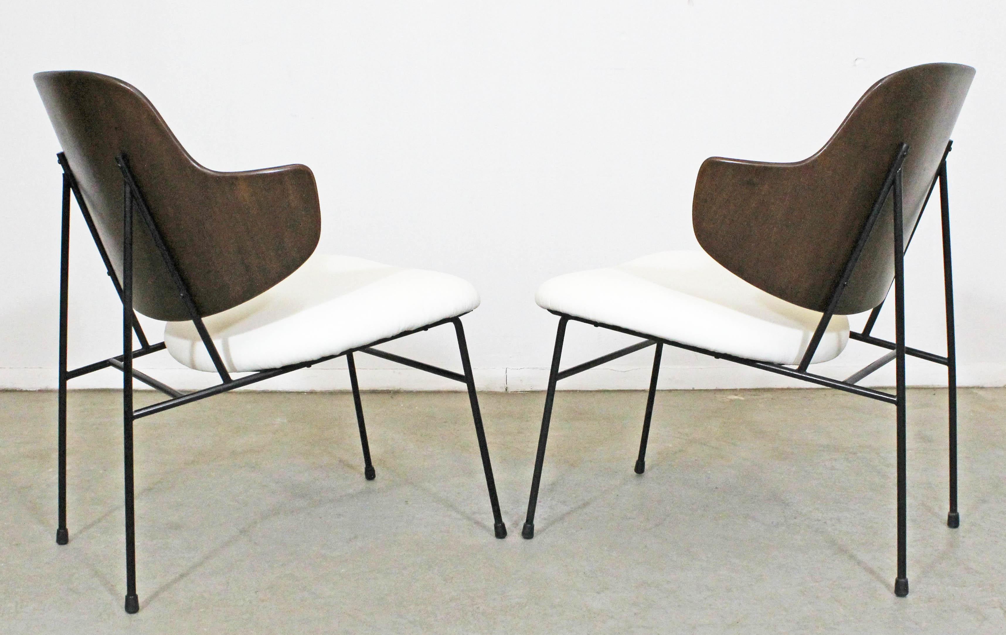 What a find. Offered is a set of 2 original 'Penguin' chairs designed by IB Kofod Larsen for Selig. These chairs were designed in 1953 and had a limited production through the 1960s. They have been completely restored with refinished walnut backs,