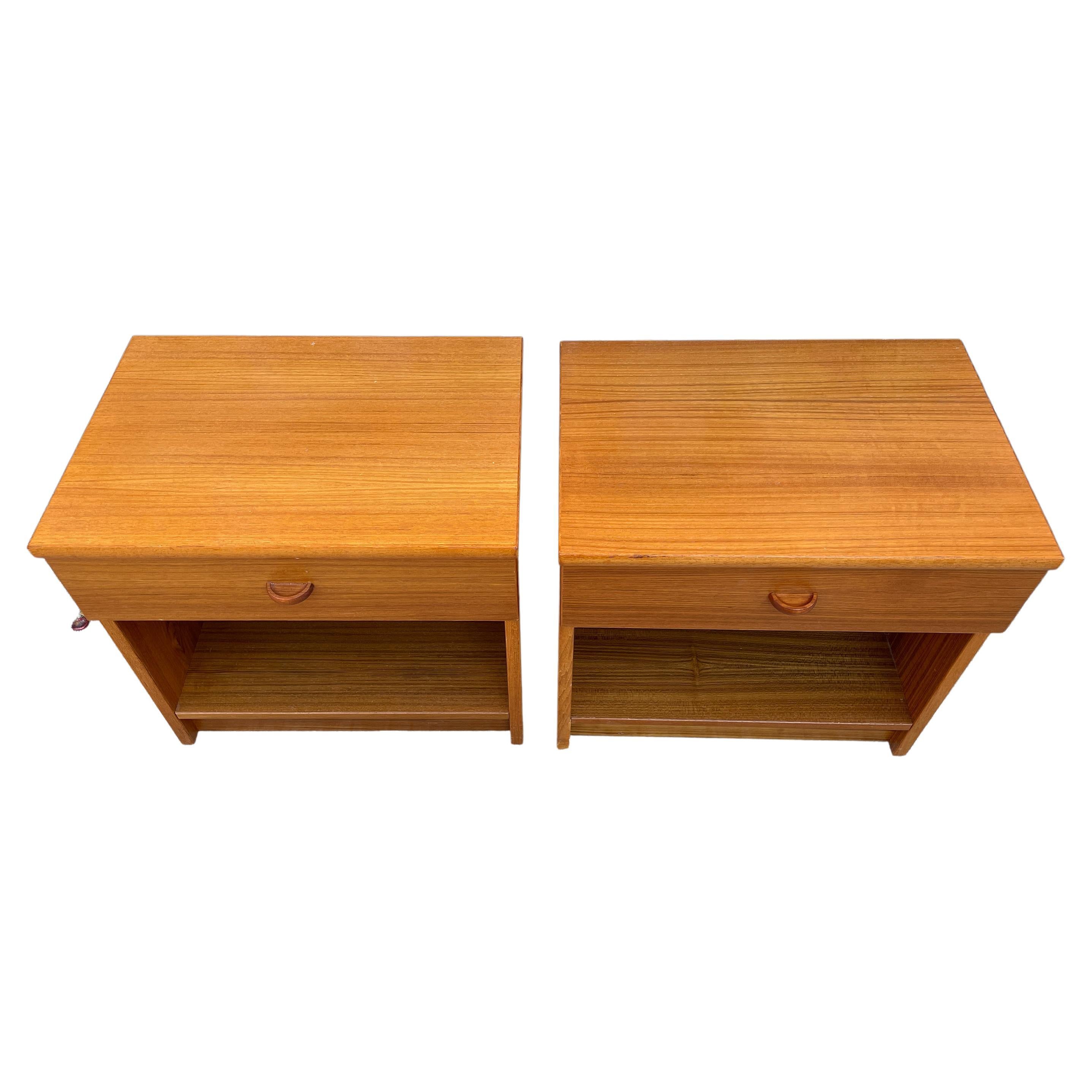 Beautiful pair of mid-century Danish modern teak single-drawer nightstands. Great simple design and great vintage condition - clean inside and out. Drawers slide smooth and with open space below drawer. Great light teak wood grain with solid teak