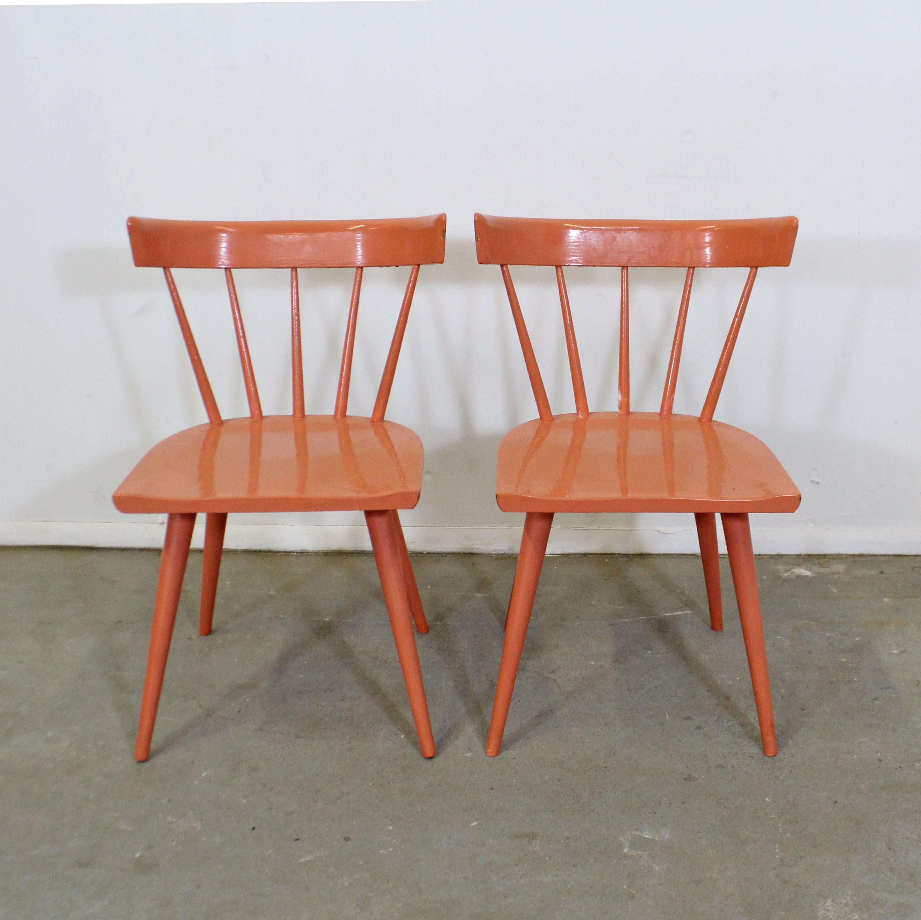 What a find. Offered is a vintage pair of spindle-back side chairs, designed by Paul McCobb for Planner Group. These are solid chair that have been repainted by their previous owner. They are in good, structurally sound condition with some paint