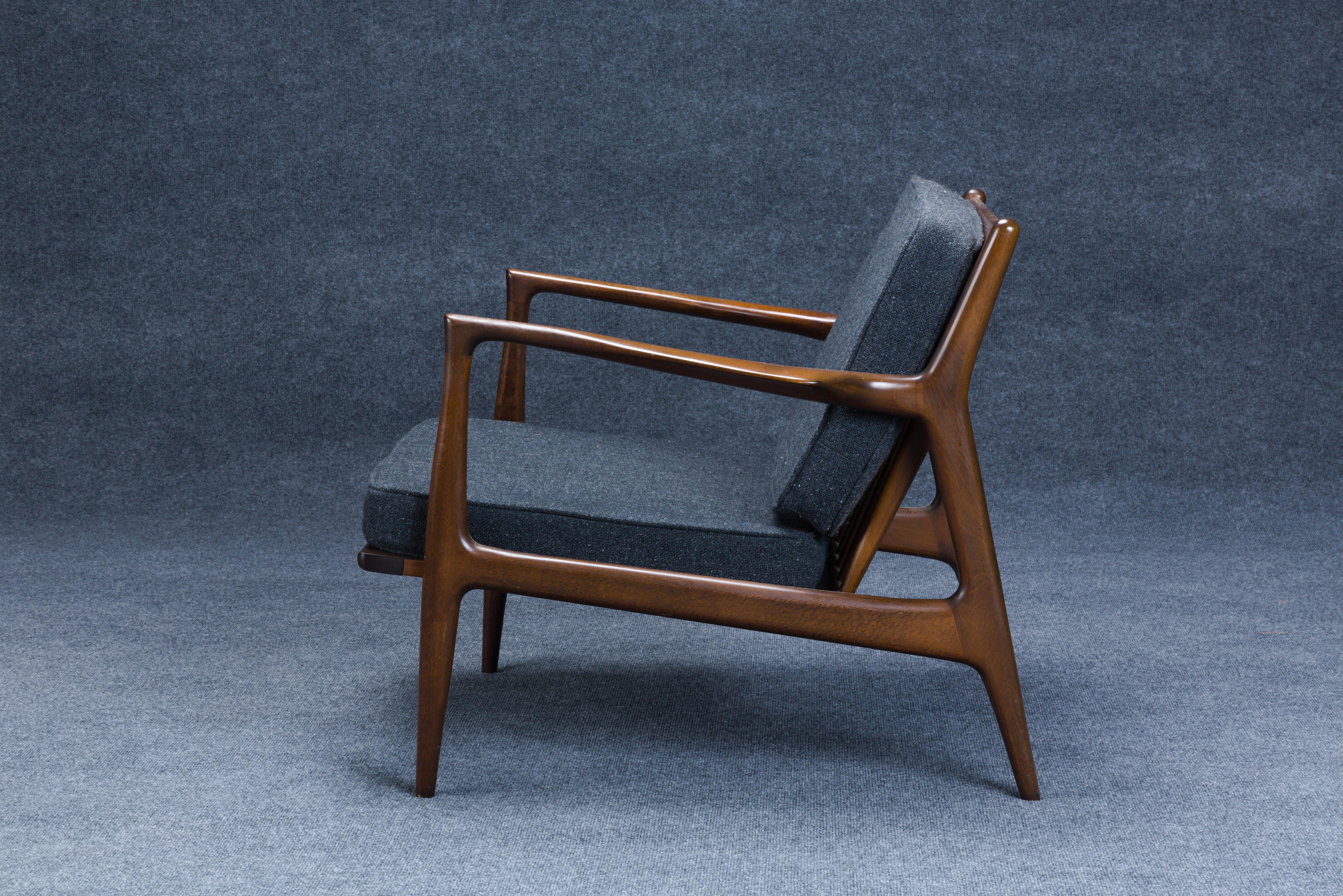 Two Ib Kofod-Larsen (Danish, 1921-2003) for Selig Spear Lounge Chairs, Denmark, c. 1960, walnut, brass, steel, each with round Selig tag, ht. 26 1/2, wd. 30, dp. 30 in.