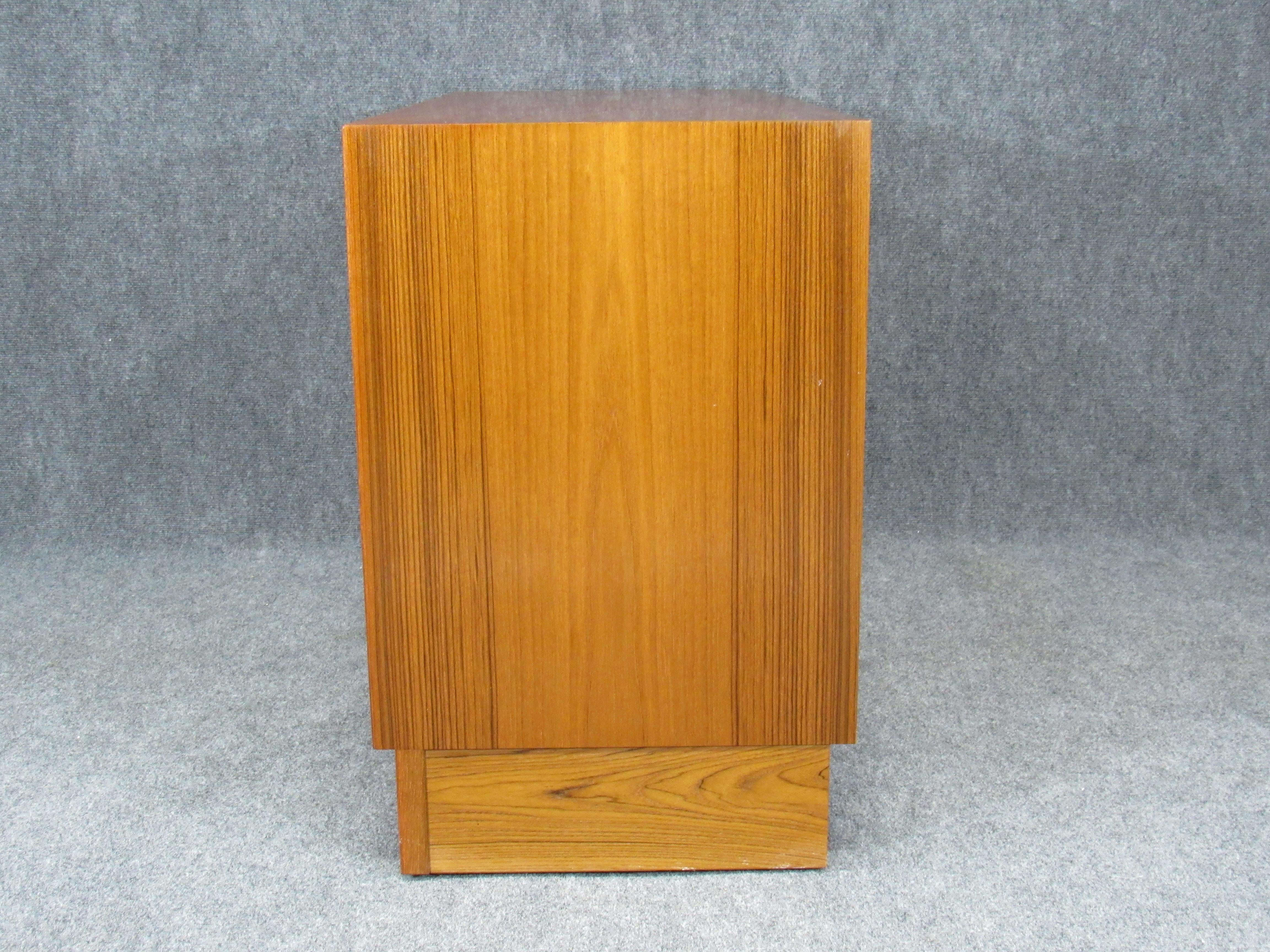 Set of two matching 1960s Mid-Century Modern credenzas with plinth base Danish modern Poul Hundevad for HU teak. Credenzas have 2 doors that glide smoothly and are fronted with sculpted pulls. Well crafted and executed pieces. Marked with HU paper
