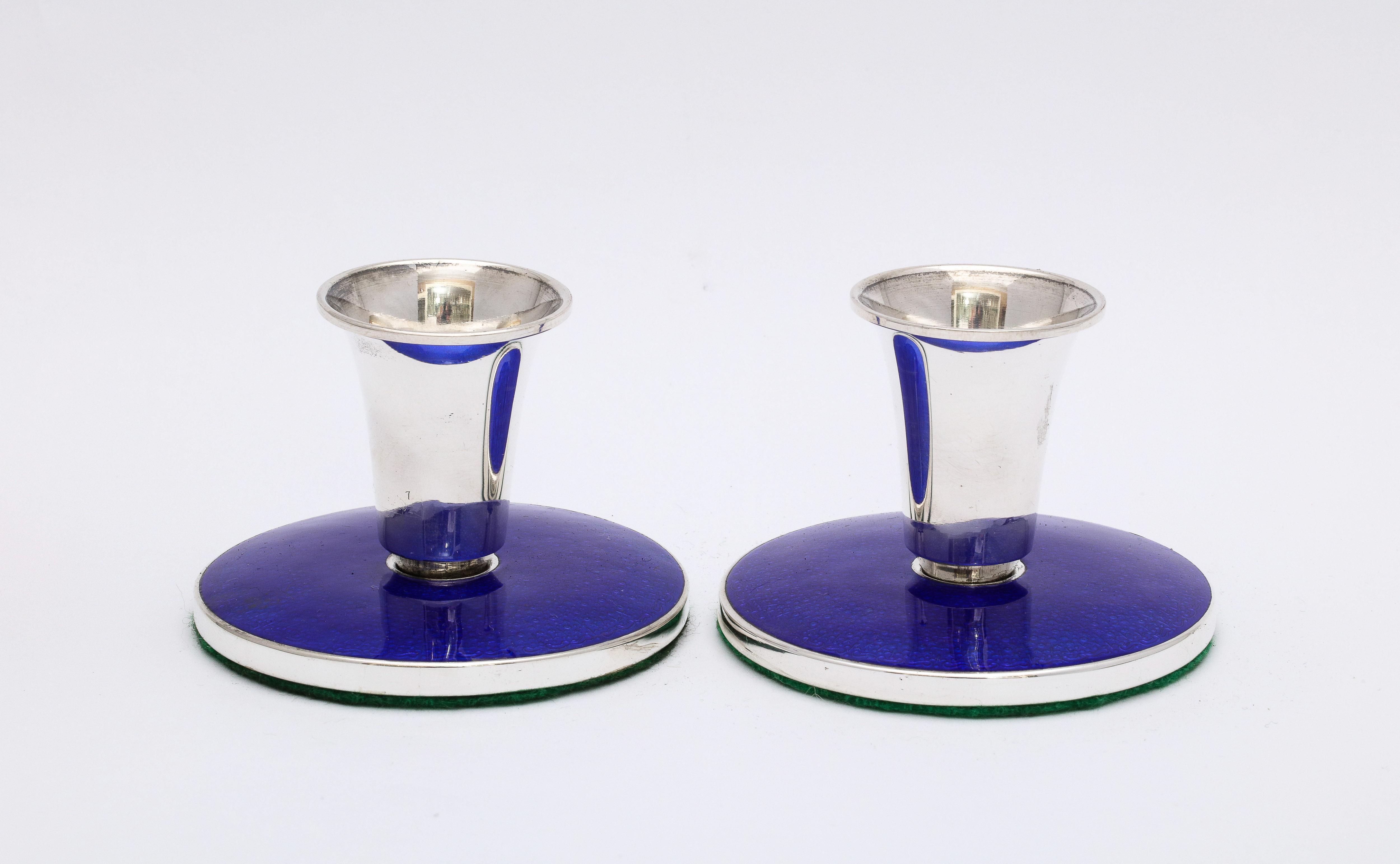 Pair of Mid-Century Modern, sterling silver and cobalt blue guilloche enamel (which is in excellent condition) candlesticks, Denmark, 1960s, Meka Co. - makers. Each measures 2 1/4 inches high x 3 inches diameter. Underside of each is covered in