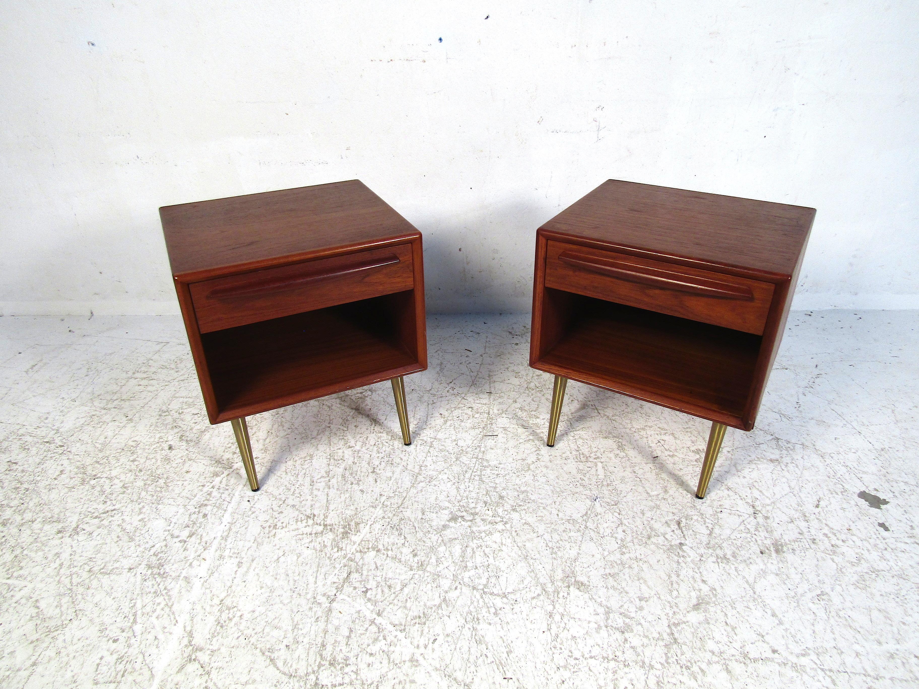 This elegant pair of Danish nightstands feature teak wood and brass legs. Simple in design yet full of style this set will add a degree of sophistication to any bedroom. Please confirm the item location with the dealer. (NJ/NY).