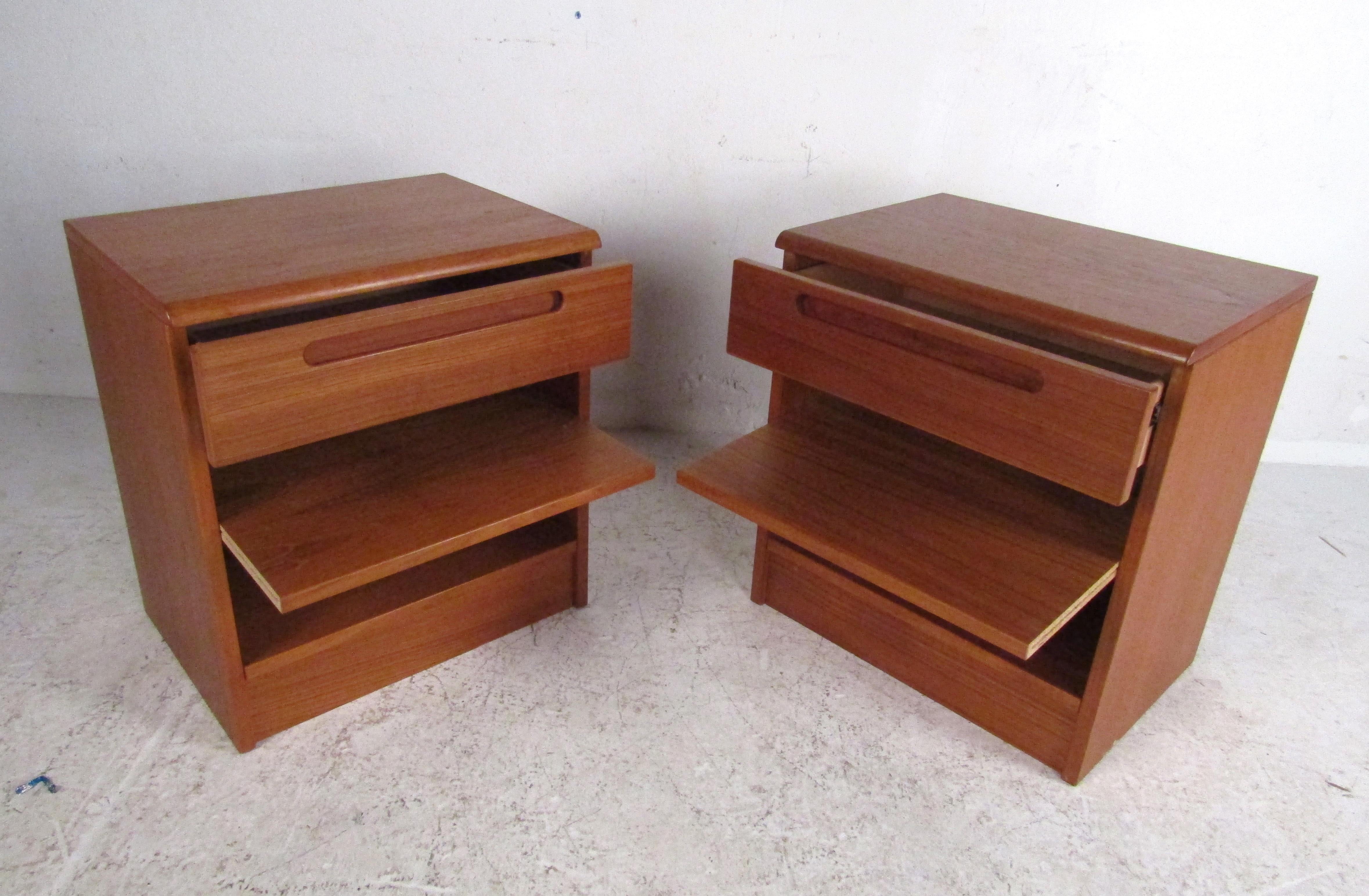 This stunning pair of vintage modern teak side tables feature a large open compartment with a pull-out shelf and a large single drawer. Well-made design stamped, 