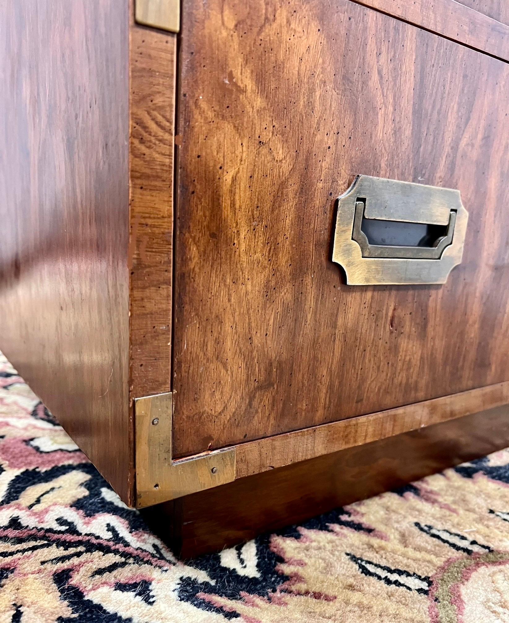 Rarely available tall set of campaign chests by Dixie Furniture, circa 1960s.
This is part of their coveted Campaigner line, which features dramatic wood grain and five spacious, dovetailed drawers. All original including the brass hardware and