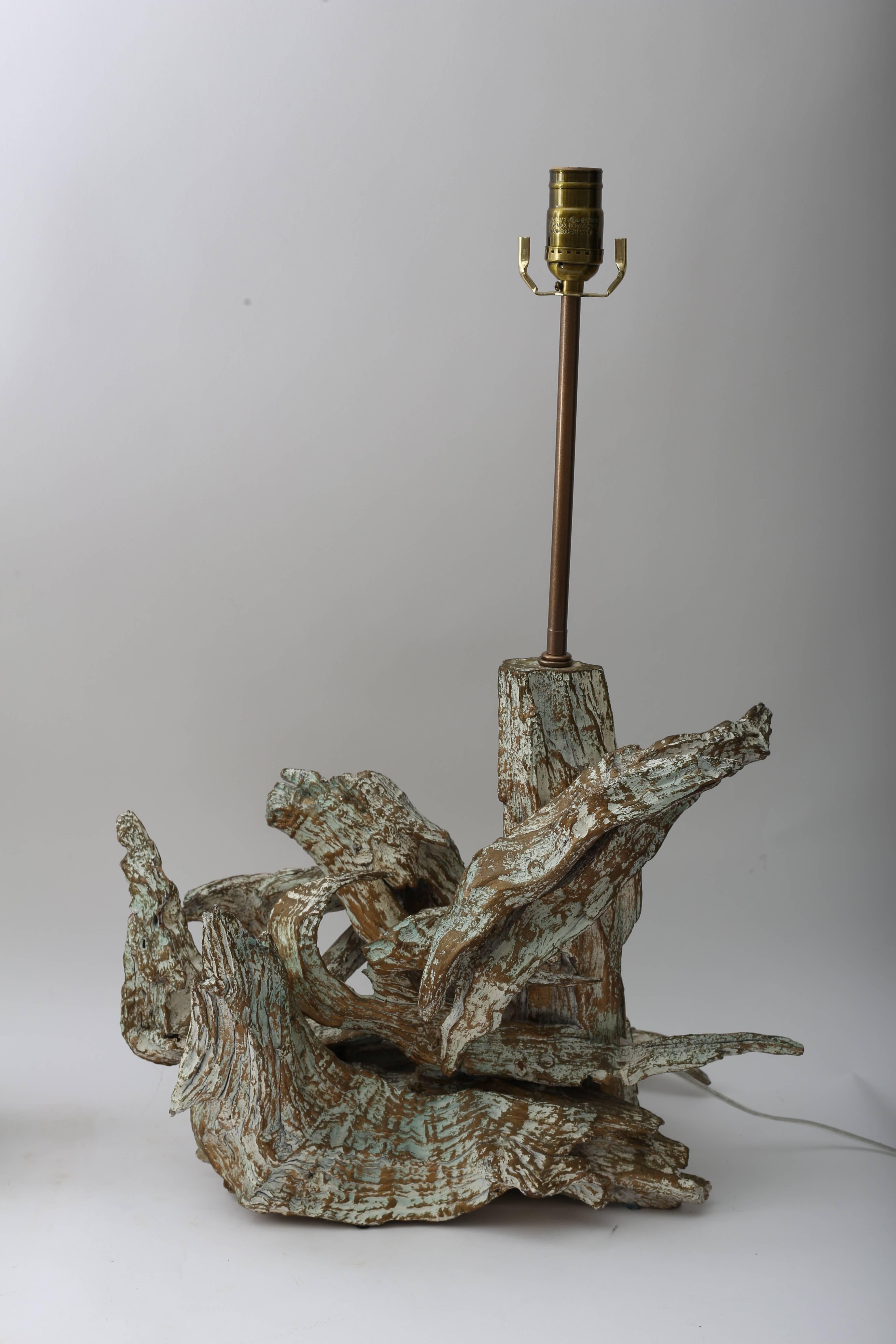This pair of organic driftwood table lamps date to the mid-20th century and have a slight bronze/gold wash to them and they have been professionally rewired, new hardware and have dimmer switches.

Note: Dimensions of lamps are slightly different.

