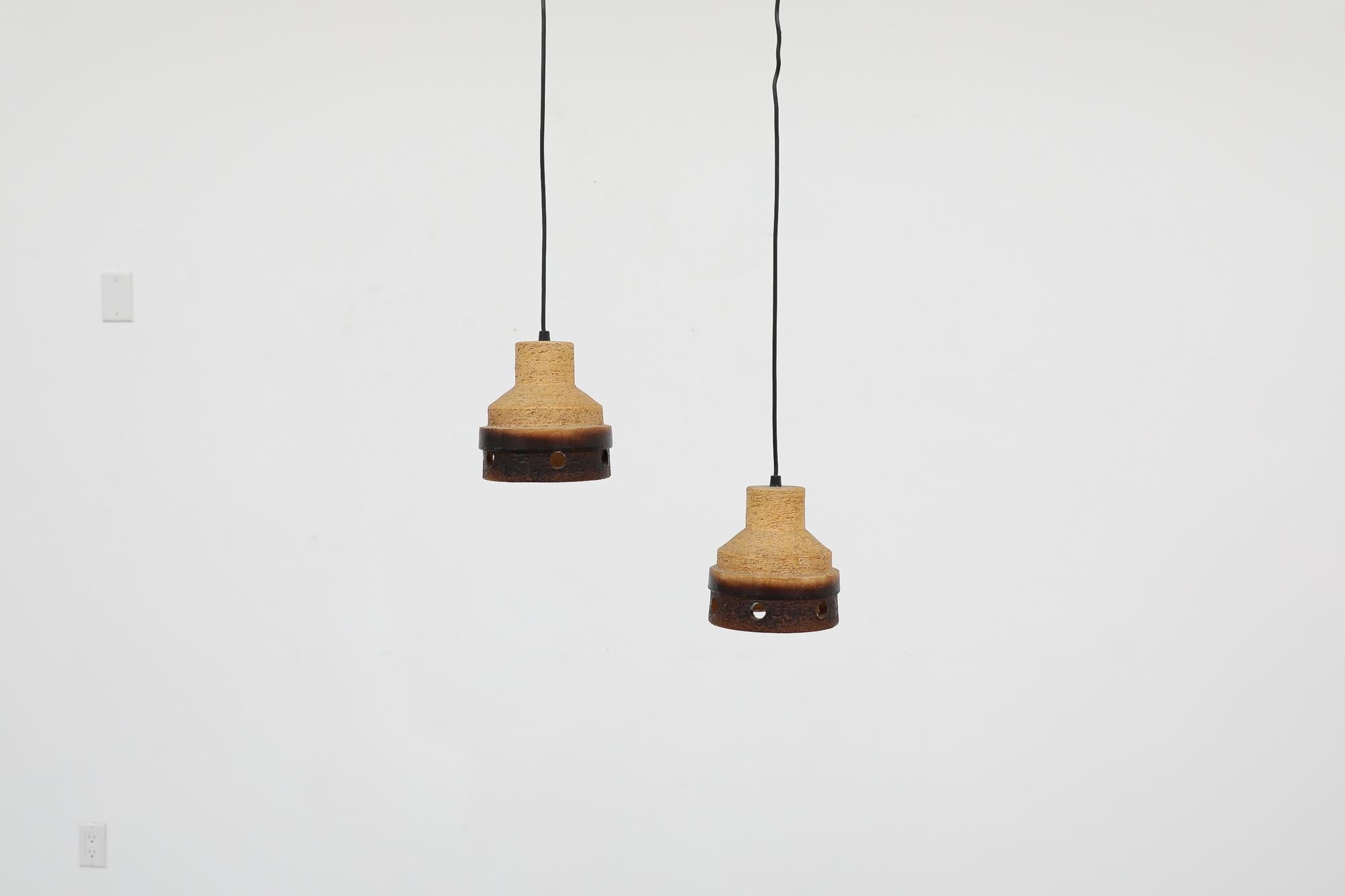 Pair of Mid-Century Dutch, Hannie Mein style, two toned ceramic pendant lamps with decorative and functional cut outs. In original condition with normal wear consistent with age and use. Priced as a pair.