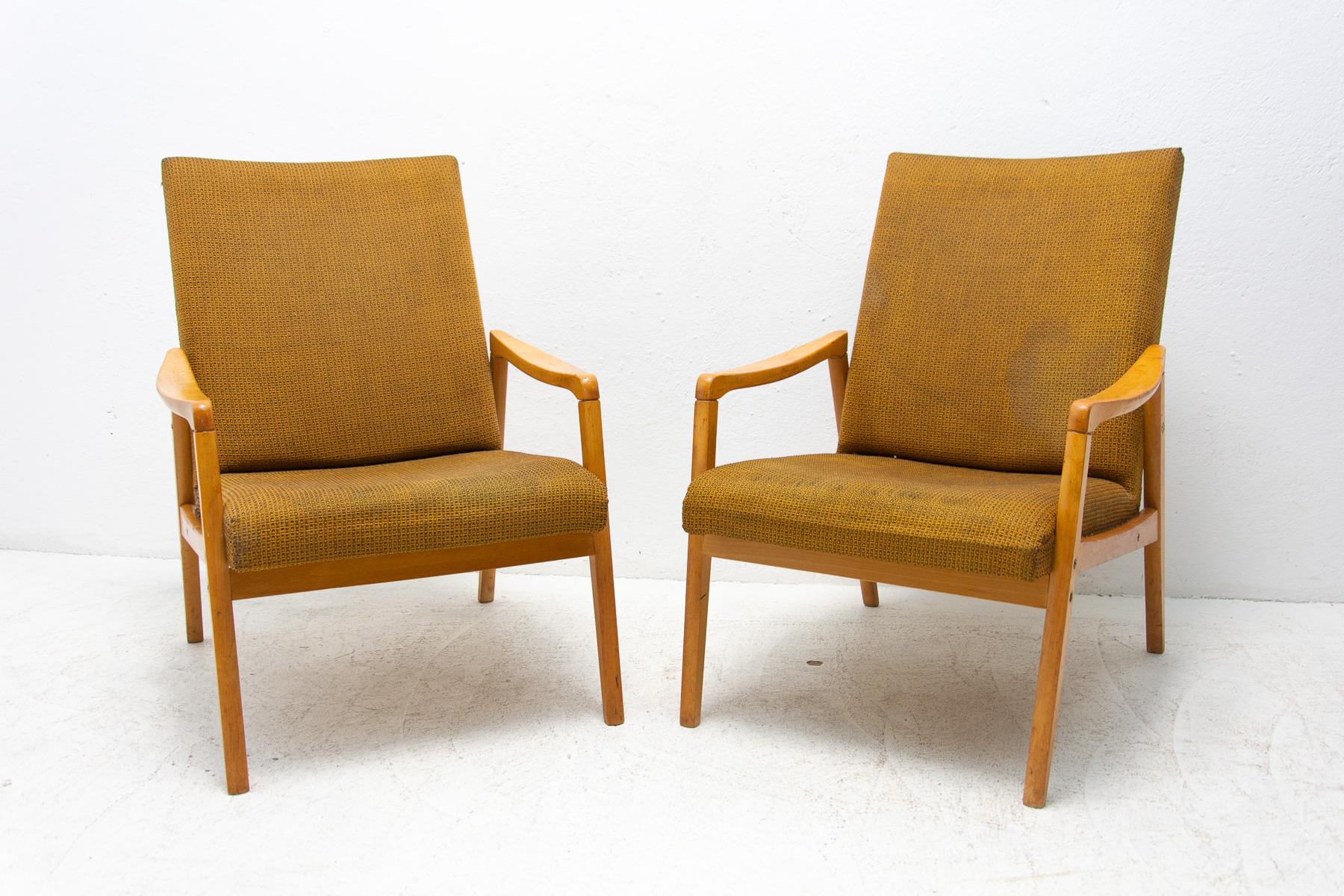 A pair of armchairs, made in the former Czechoslovakia in the 1970´s. It was designed by Jirí Jiroutek for Interiér Praha as part of U-550 living room set. The structure is made of beech wood and the chairs have original upholstery. The chairs are