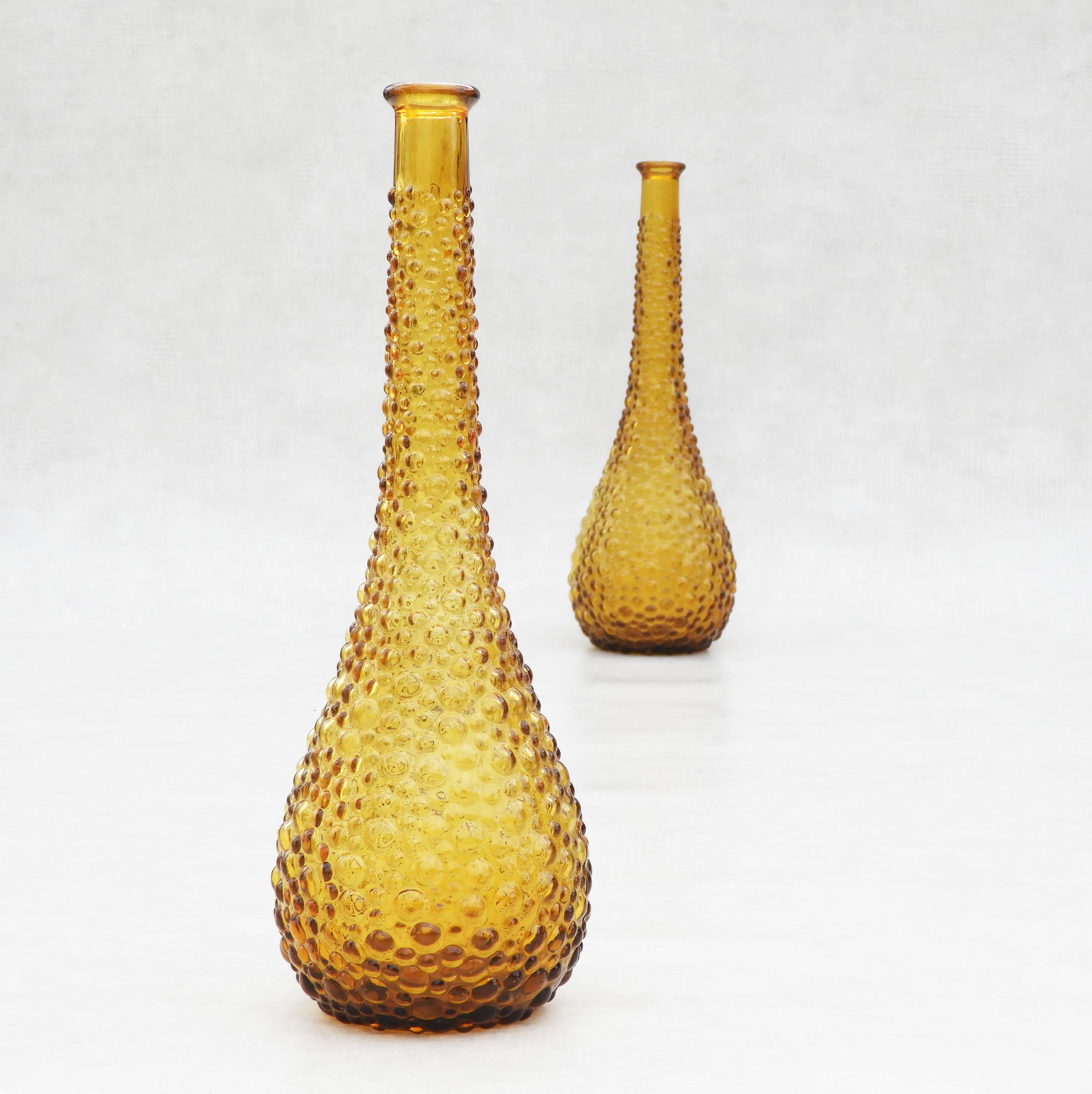 Vintage pair of stylish amber bubble glass bottle vases by Empoli, Italy, C1960. 
Attractive golden amber colouring and organic form textured bubble surface.
In very good vintage condition with no losses to glass.

Dimensions: Diameter: 5.9 in. (15