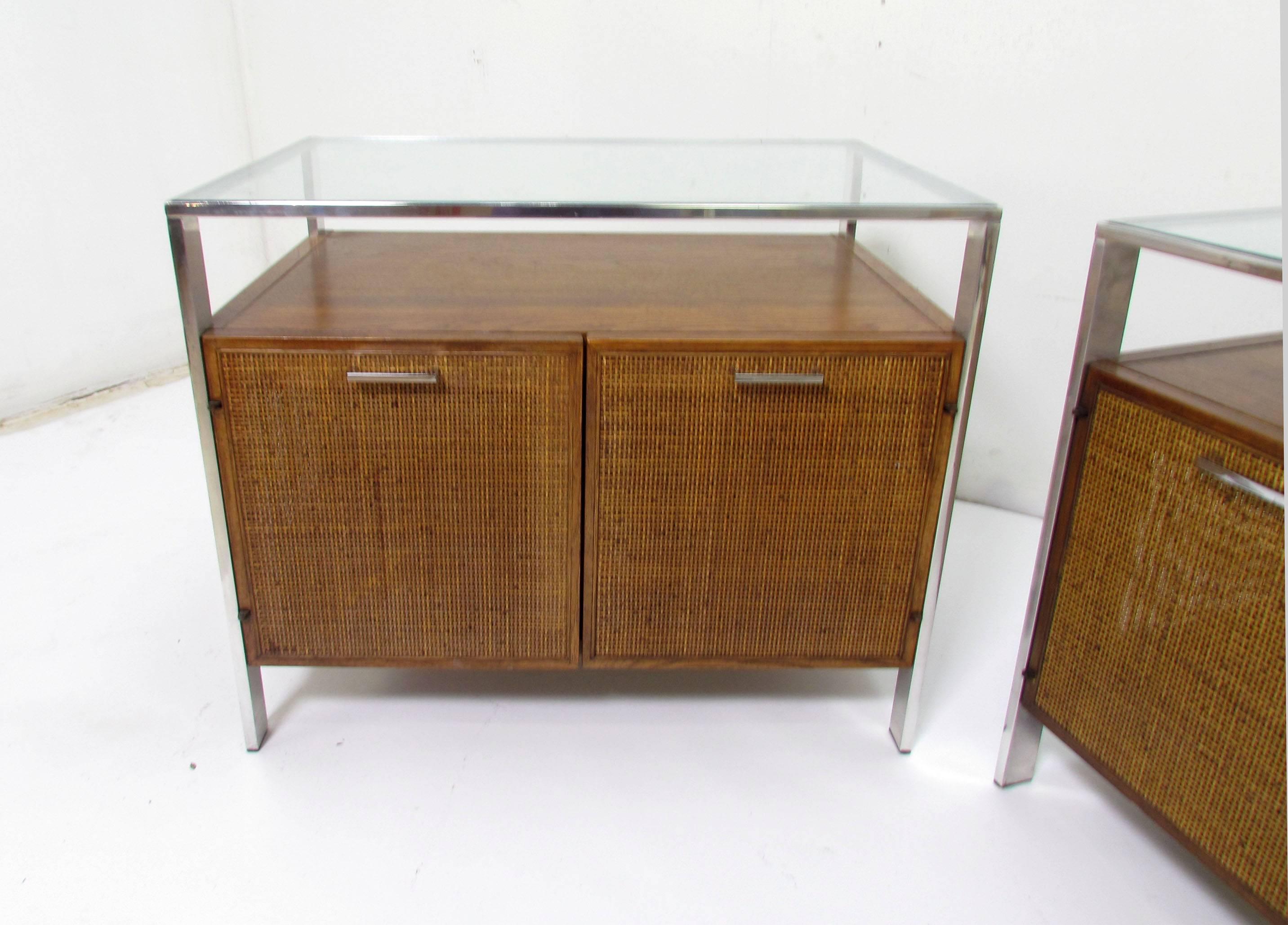Pair of midcentury end tables with cane doors and side panels, walnut cases, and glass tops inset into a chrome framework, circa 1960s. Unmarked, most likely by Jack Cartwright for Founders, in the style of Milo Baughman.