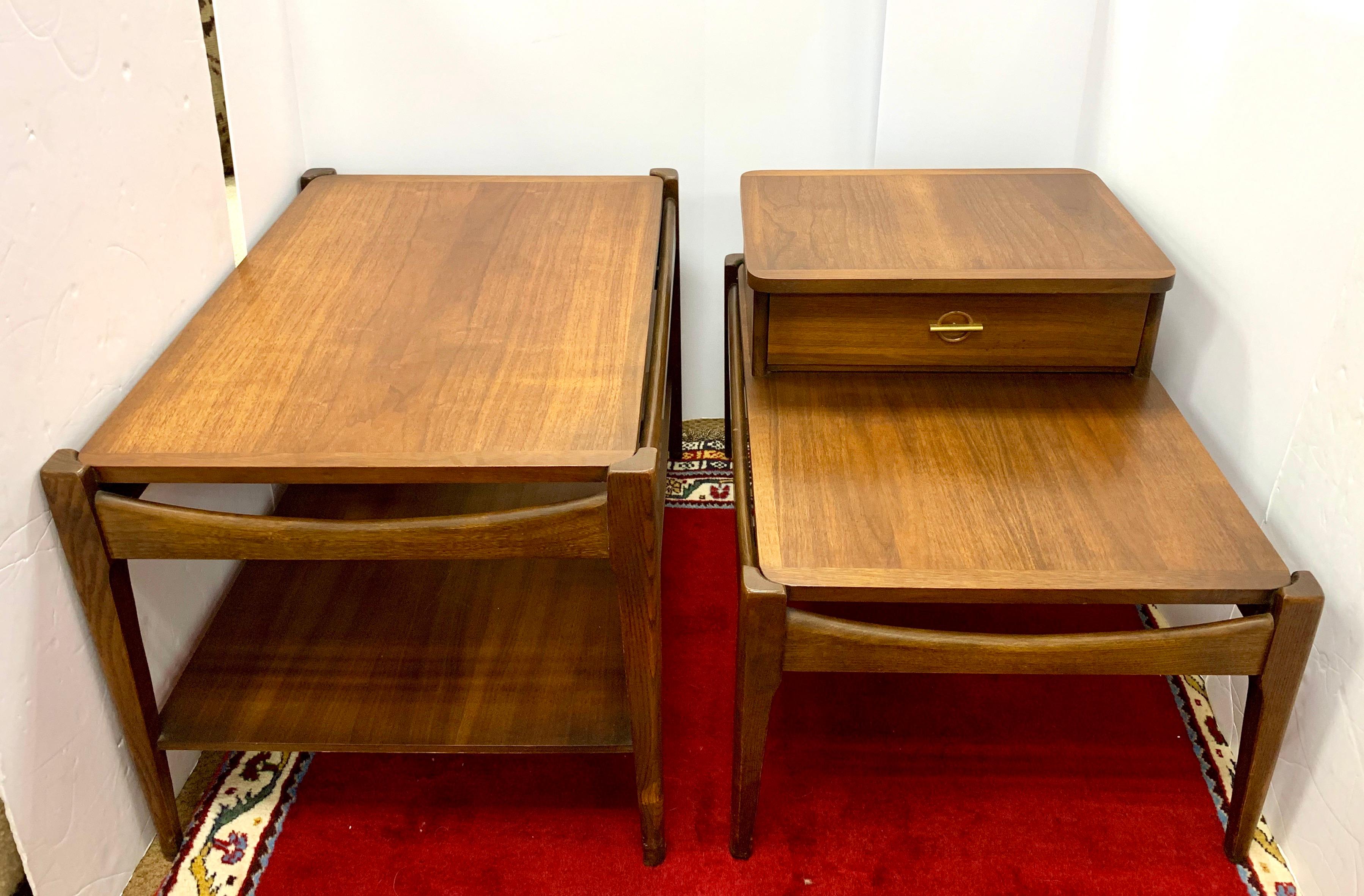 Vintage pair of Bassett 1970s midcentury teak nightstands. While they have the same dimensions, they are different in terms of shape, see pics.