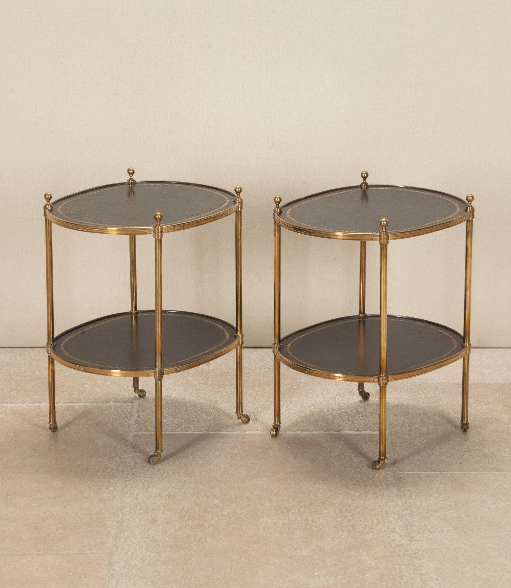 A fabulous pair of Mid-Century English brass two tier side tables. Without a doubt attributed to Mallet of Bourdon House Mayfair. With superb black leather tops finished with gilt tooled Greek key design. Terminating on castors. Circa 1970.