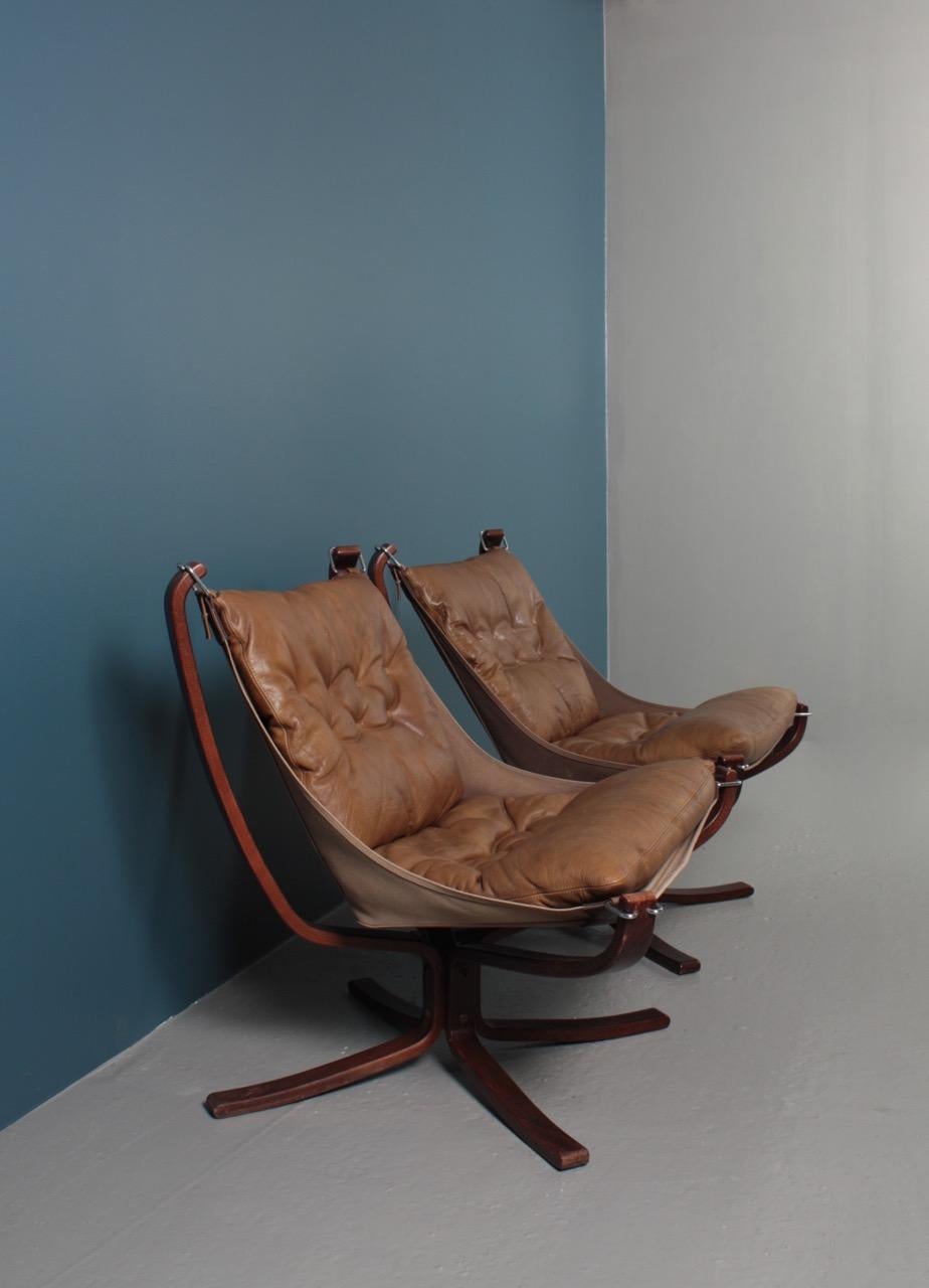 Pair Falcon chairs in patinated leather designed by Sigurd Resell, made by Vatne Norway in the 1970s. It has been cleaned, waxed, and is from a non-smoker home.