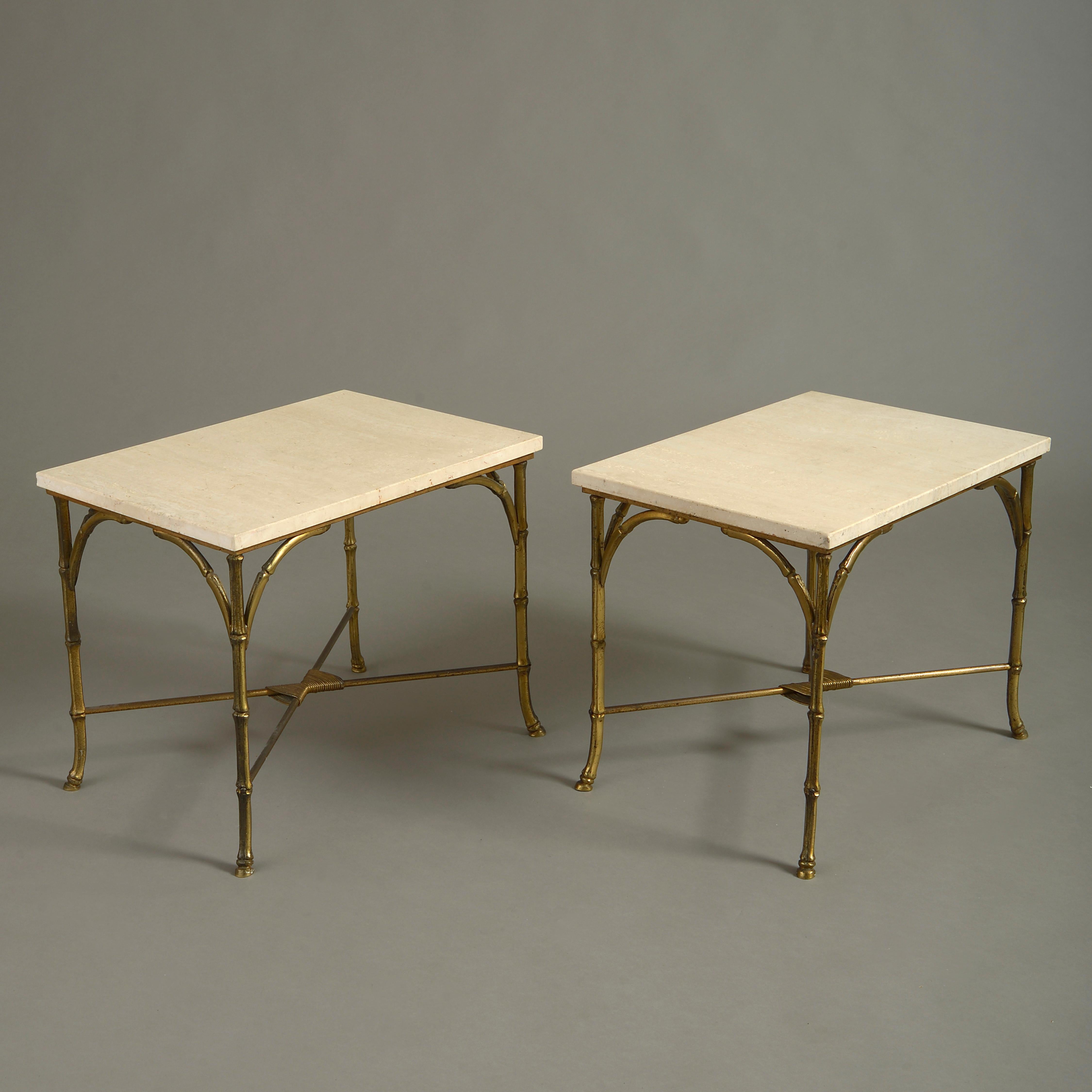 A pair of mid-20th century low end tables, the rectangular white stone tops supported upon gilt brass faux bamboo legs headed by brackets of the same and conjoined with an X-form stretcher.