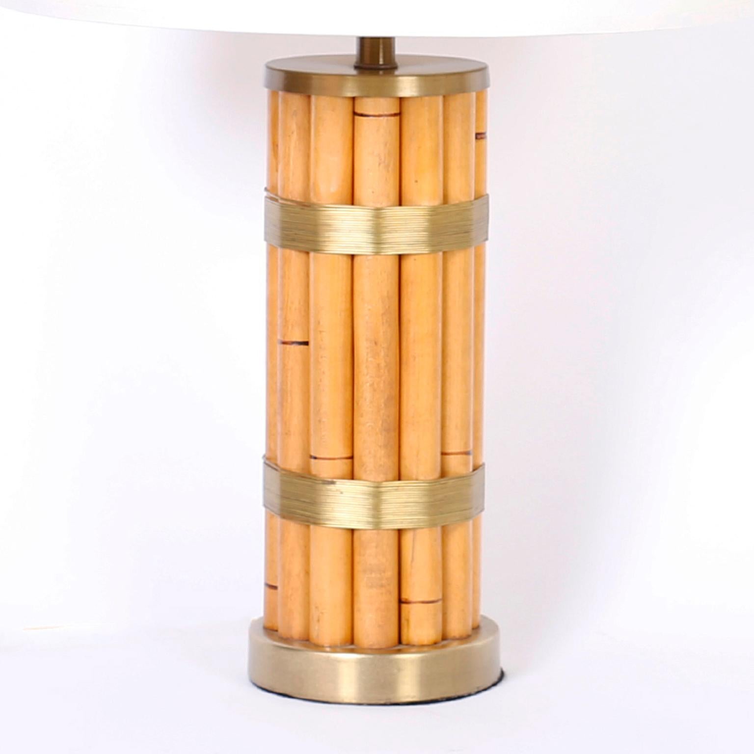 In vogue pair of table lamps composed of hardwood turned rods, probably ash, burned like bamboo and banded with brass string.