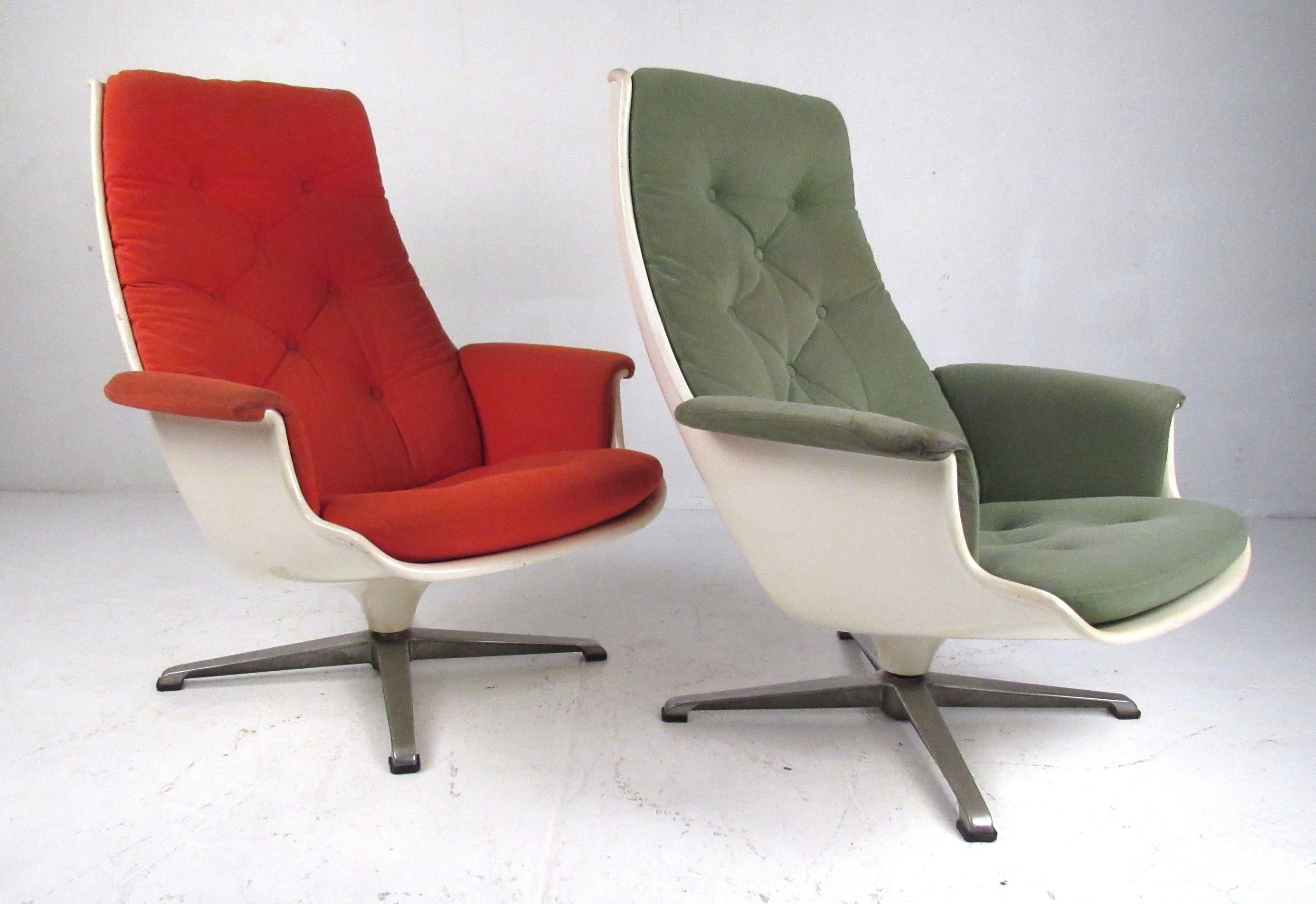 Matching pair of vintage fiberglass shell lounge chairs on swivel bases. Reminiscent of the classic Eames lounge, these stylish chairs are very comfortable and will compliment any home or office environment. Please confirm item location (NY or NJ)
