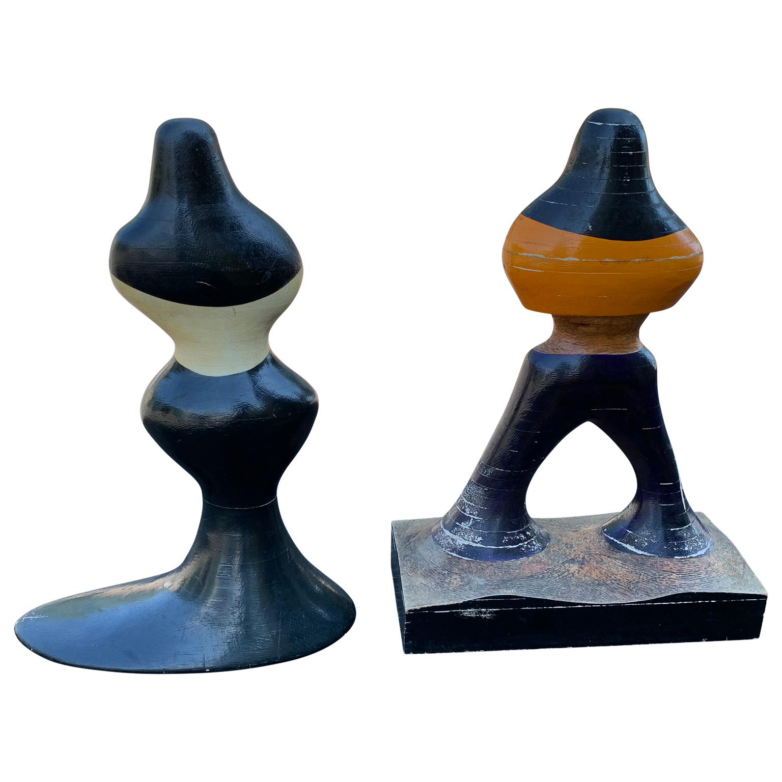 Pair of mid-century figurative sculptures of woman and man in painted wood.