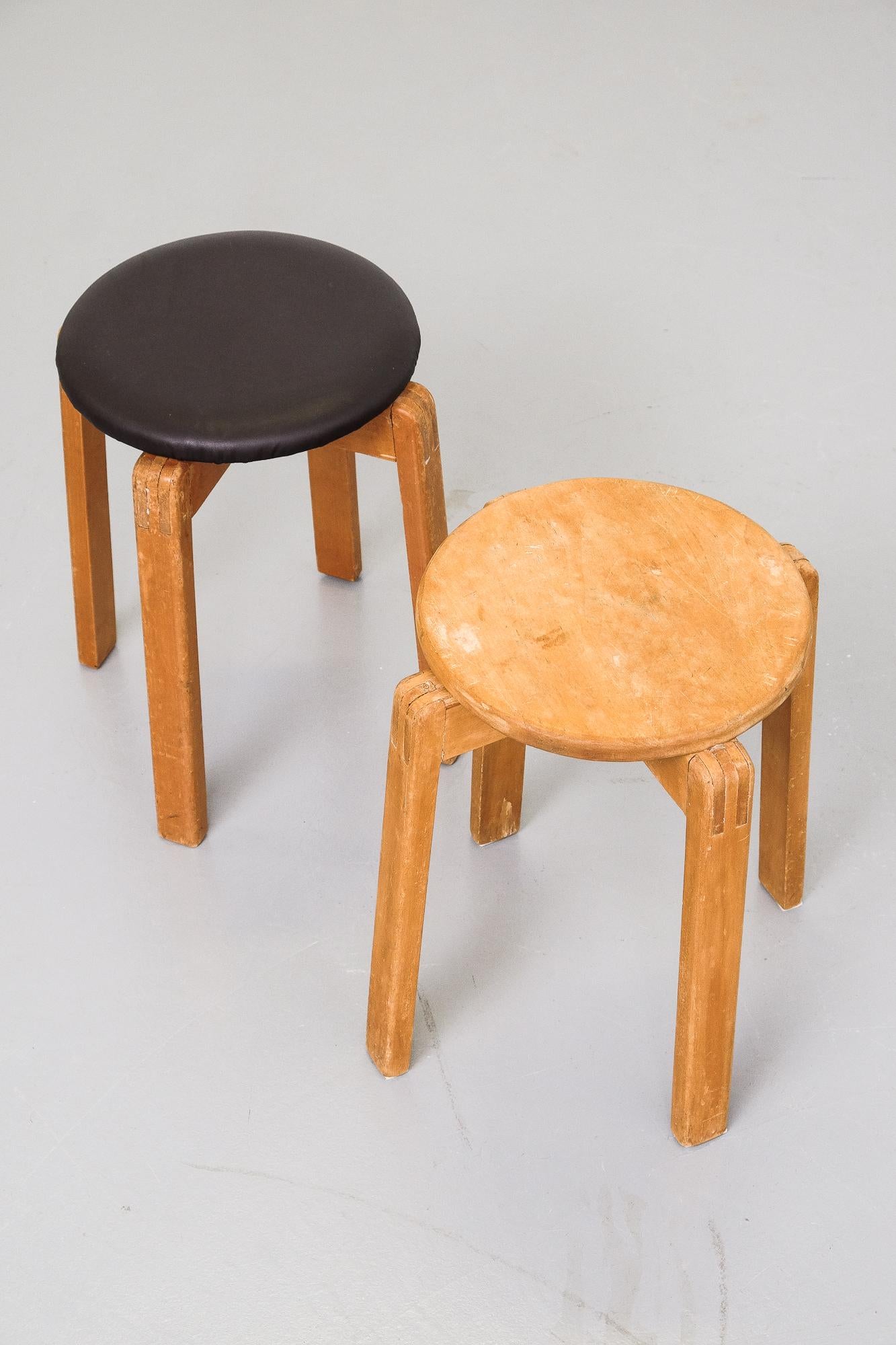 A pair of nicely patinated 1950s Finnish wooden stools. One with original patina on seat and the other with new dark brown leather upholstery.

Designer unknown.
