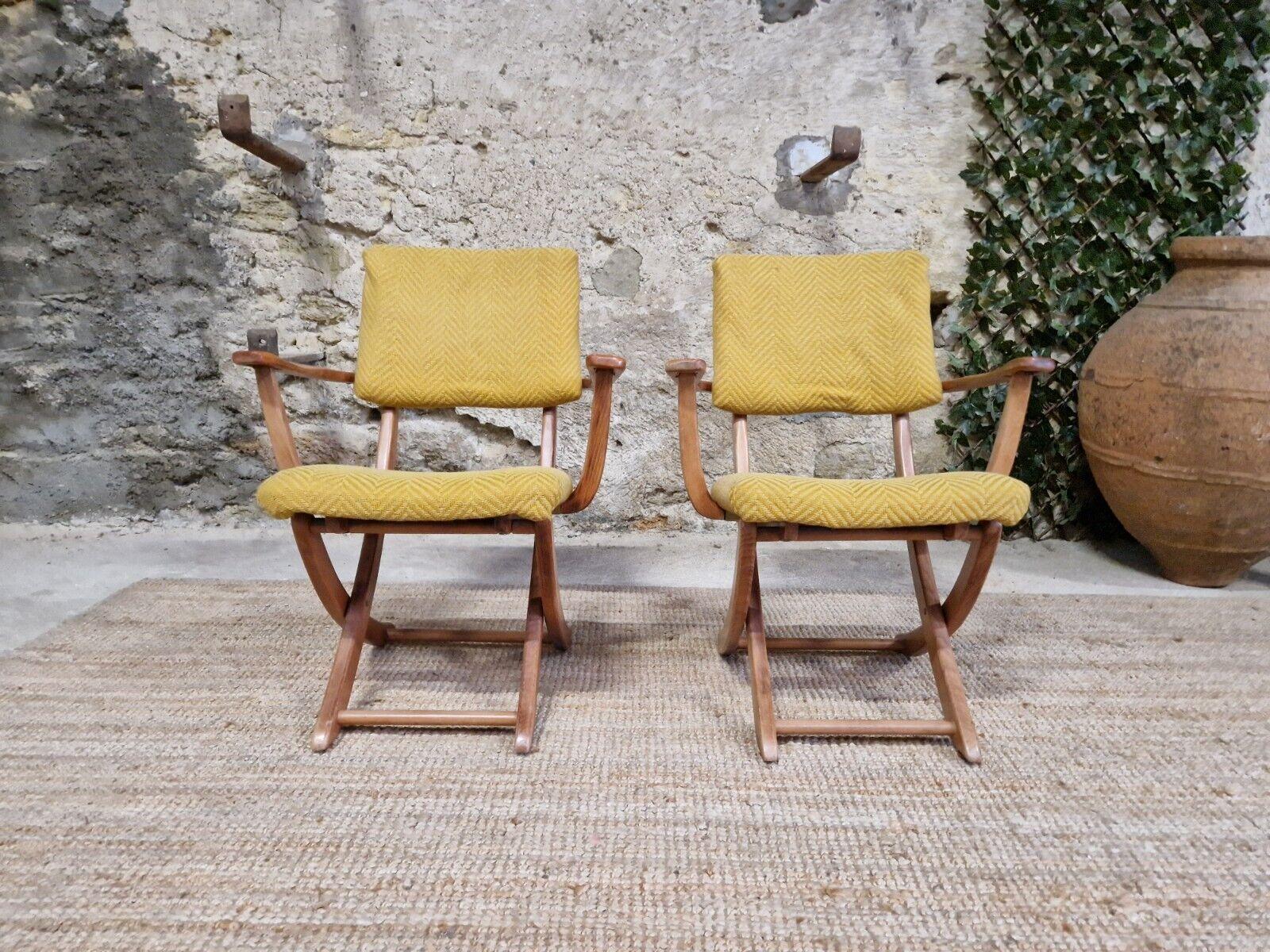 Introducing a stunning pair of Rocaille armchairs from Denmark, crafted from high-quality teak wood with a smooth finish. The beautiful yellow colour of these chairs adds a pop of brightness to any indoor space, and their foldable design makes them