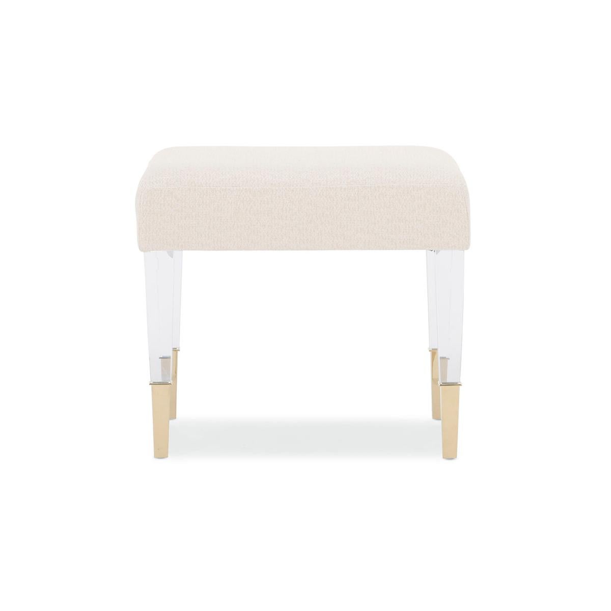 While petite in size, its charming character makes a big impact. It wears a luxurious, soft neutral fabric and sits upon chic acrylic legs capped with metal ferrules in a sparkling Whisper of Gold finish.

Drawing on a visually intriguing mix of