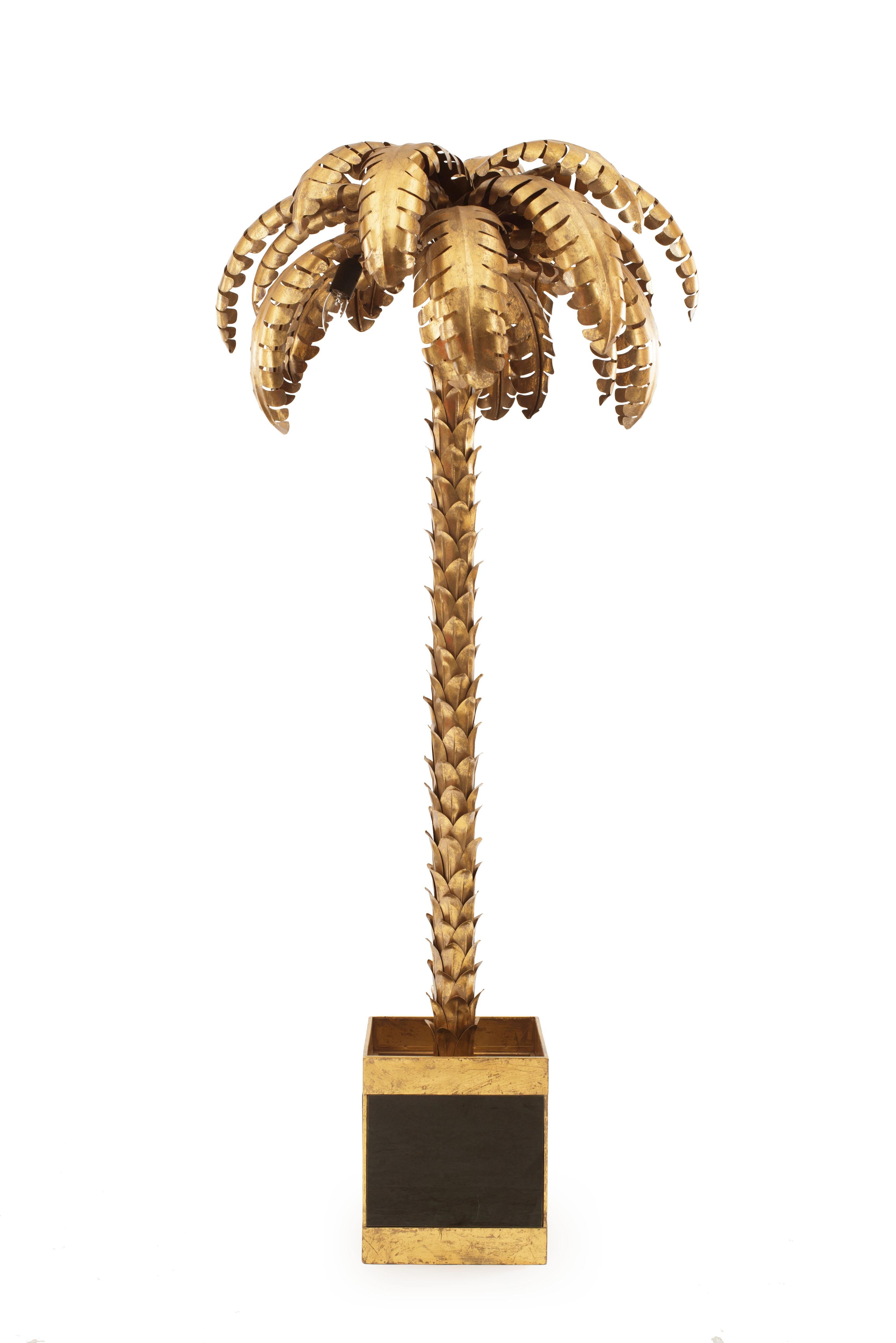 Pair of midcentury European (1960s) gilt metal palm trees electrified as floor lamps and supported on a square jardiniere base. In the style of Maison Jansen Palm tree floor lamps.