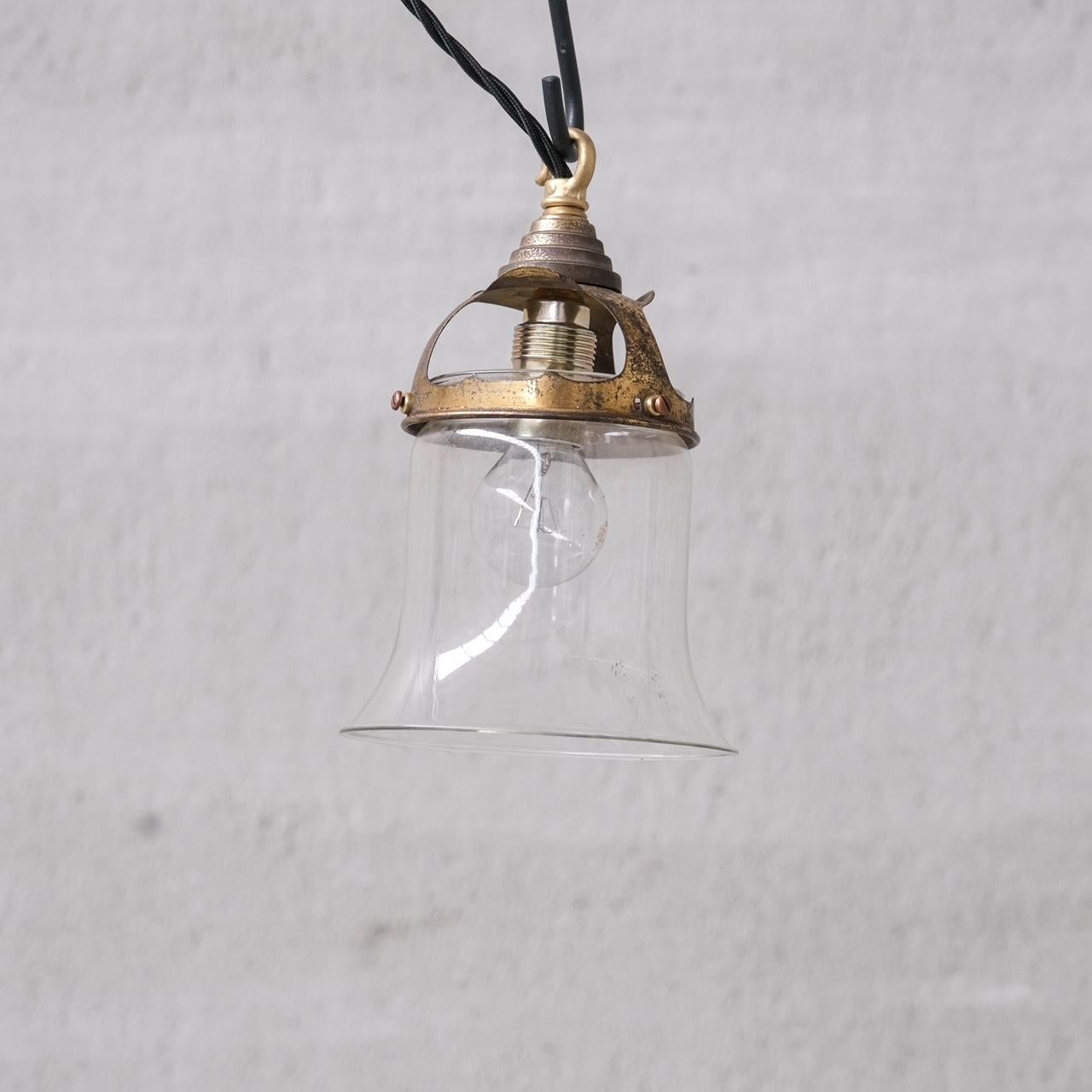 A pair of classy pendants,

France, c1950s.

Brass galleries, paired with open base bell shaped clear glass pendant lights.

PRICE IS FOR THE PAIR.

No rose was retained or chain, however they are easy to source online.

Good vintage condtion,