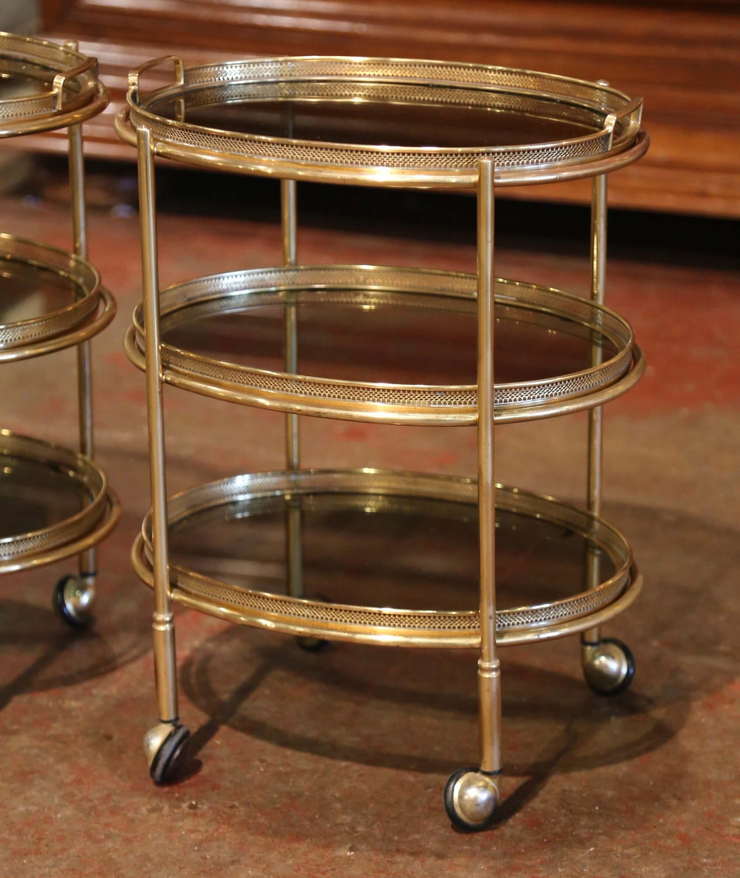 Pair of Mid-Century French Brass and Smoked Glass Three-Tier Service Bar Carts In Excellent Condition In Dallas, TX