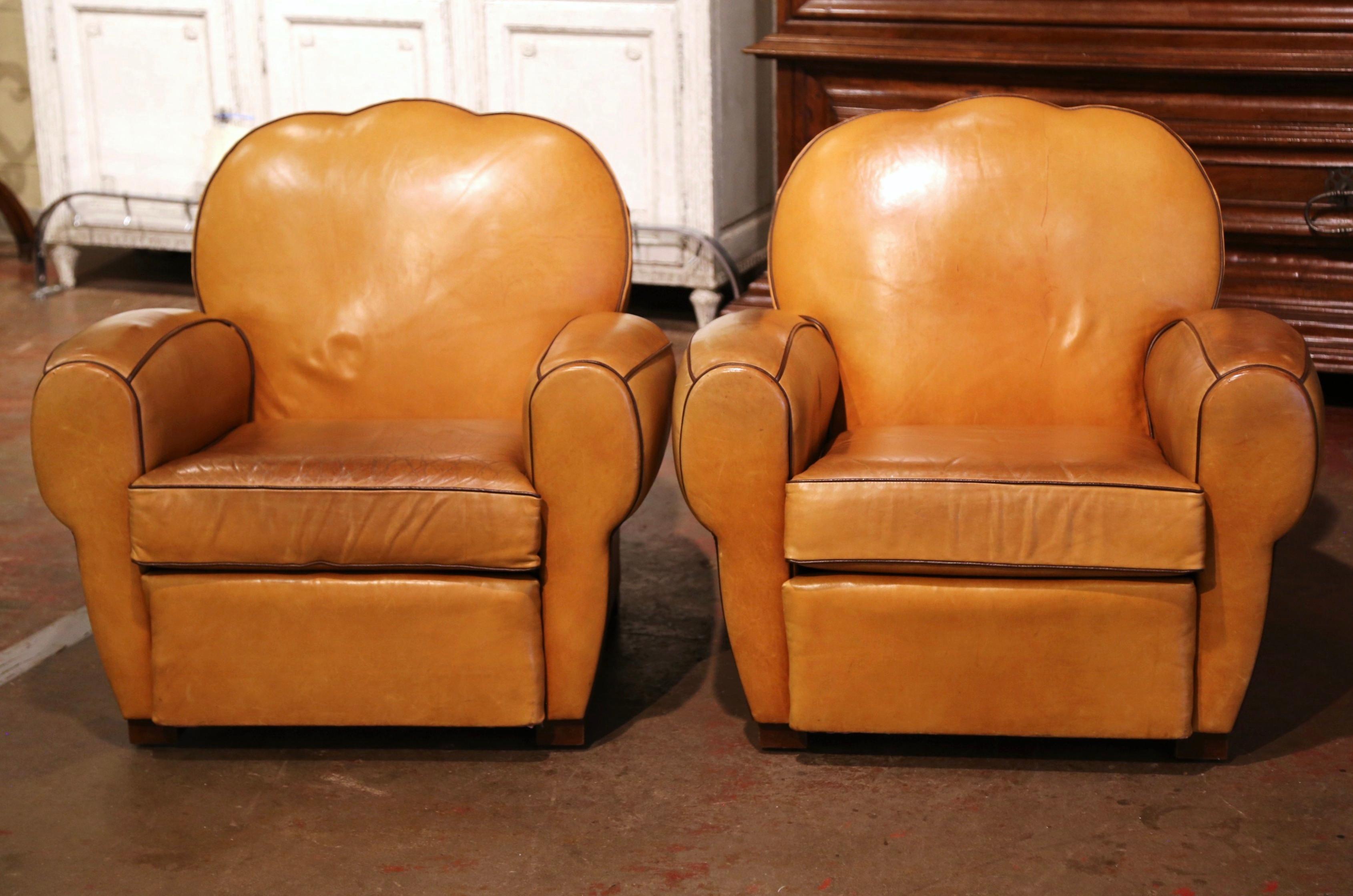 These Classic, antique Art Deco club chairs were crafted in France, circa 1960. The stately chairs Stand on square feet, and feature wide, rounded armrests, over a pitch back with arched and scalloped top shape back. The Classic, masculine French