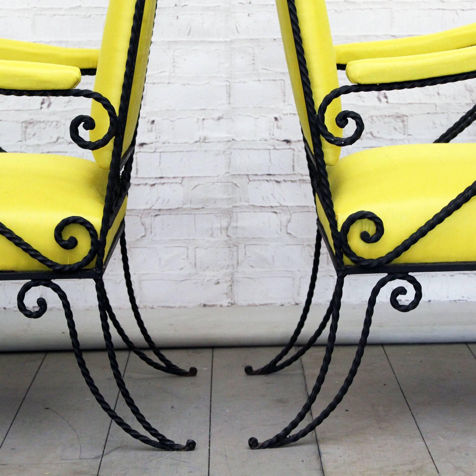 This very fine pair of ornate French armchairs has been reupholstered in yellow silk. They would work just as well inside or out. We love the three dimensional aspect of the twisted black metal work.
 