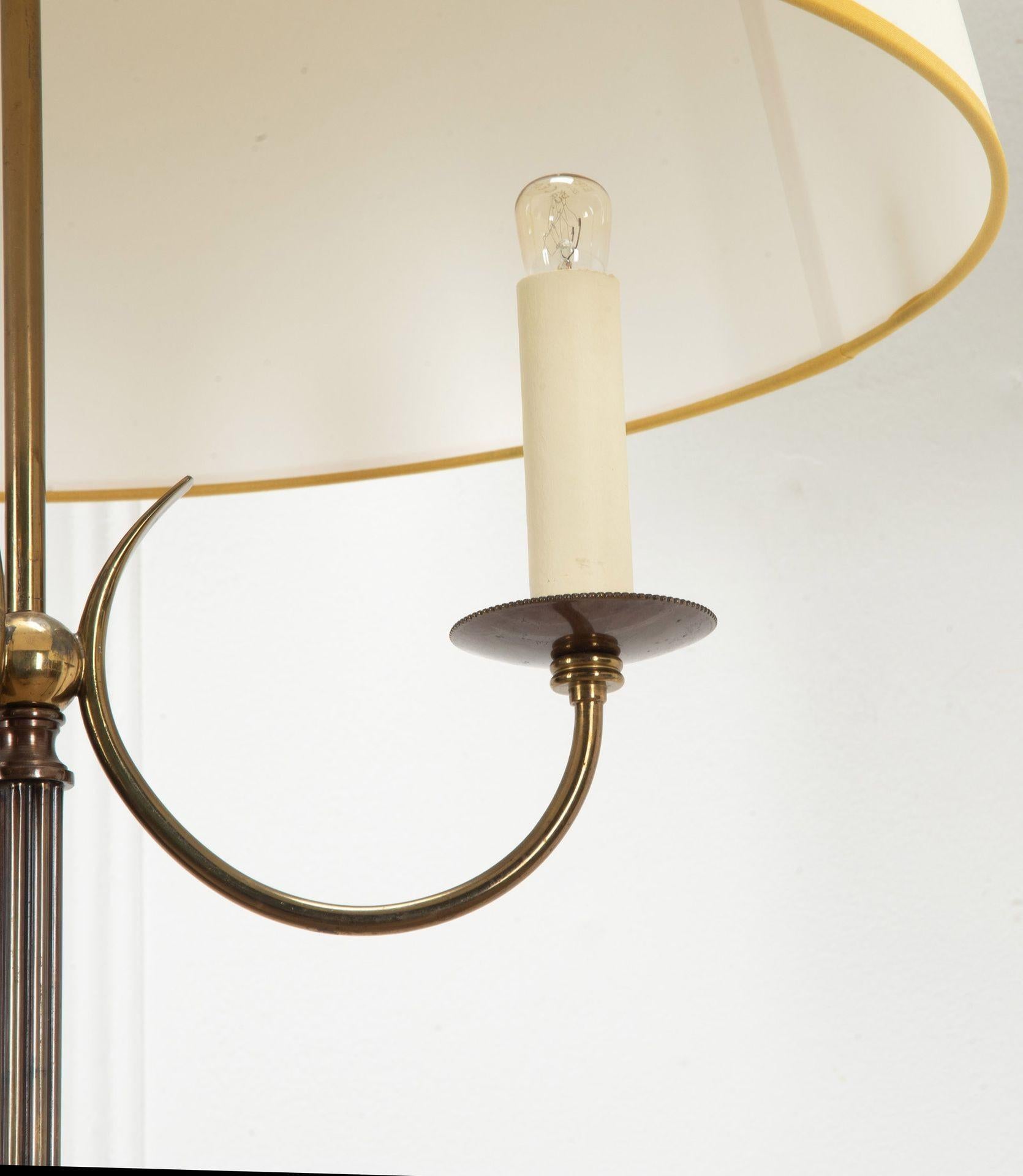 A pair of mid-20th Century French patinated brass floor lamps by Lunel.
With an elegant tripod foot and fluted shaft terminating in a spherical mount for the three light arms.
Bespoke shades in ivory cotton.
Circa 1960.