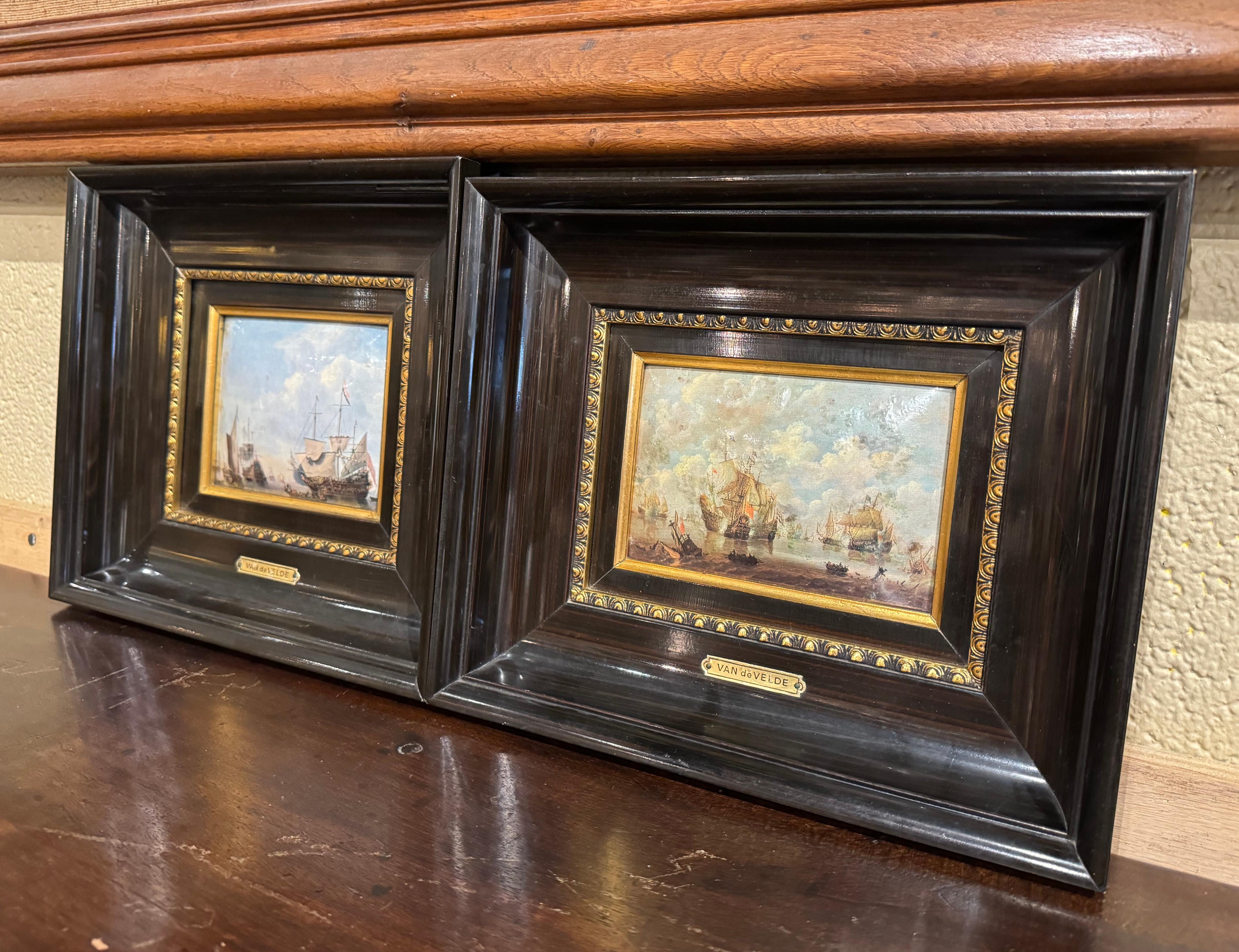 Decorate a study, office or powder room with this elegant pair of antique marine paintings. Crafted in France circa 1940, and set in a carved blackened and gilt frame, each convex enameled hammered artwork depicts a harbor scene in the manner of