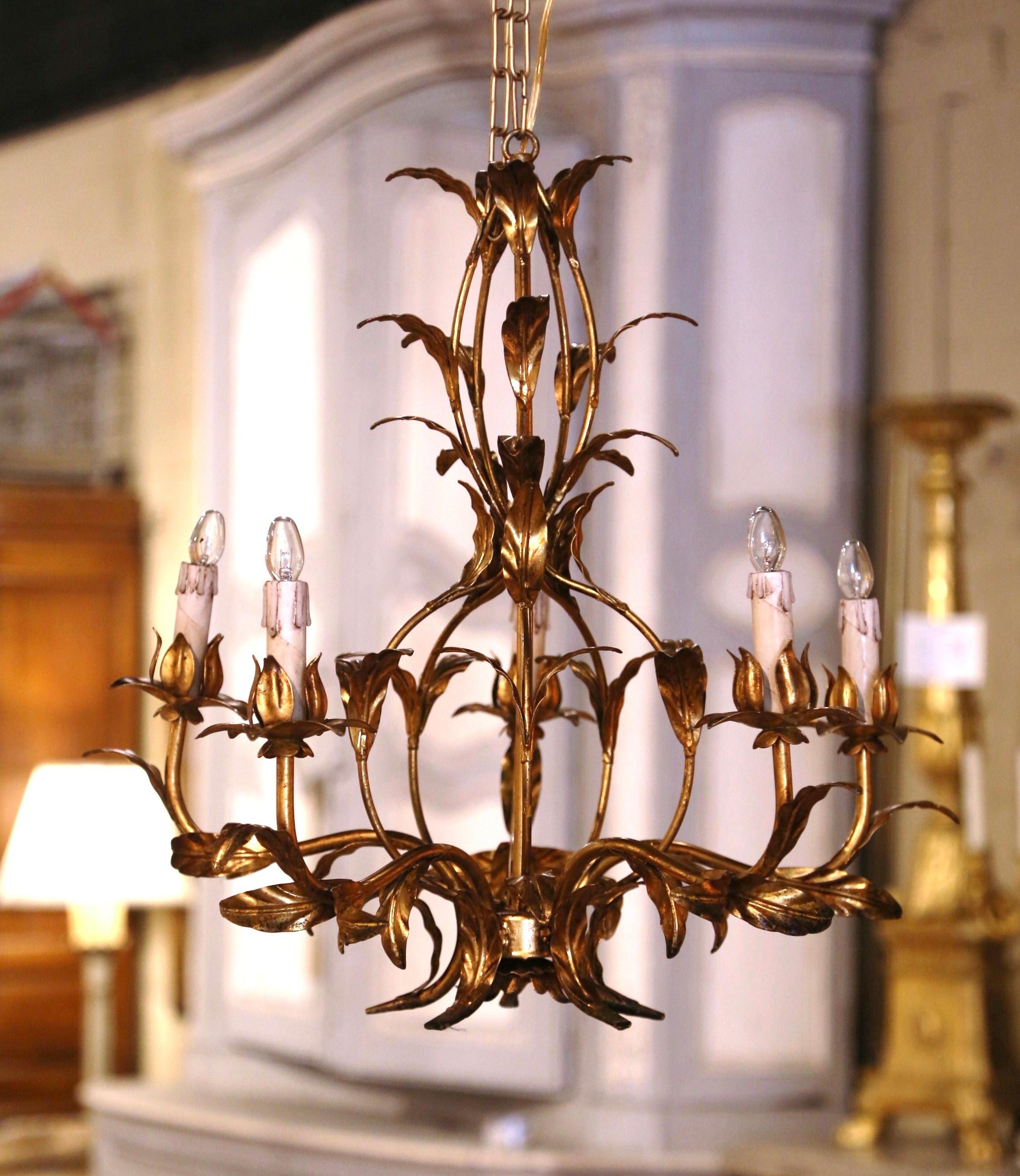 Decorate an entryway or hallway with this elegant pair of antique tole fixtures. Crafted in France circa 1950, each chandelier features an elegant, nature-inspired design with curving metal arms decorated with intricately detailed leaves and flower