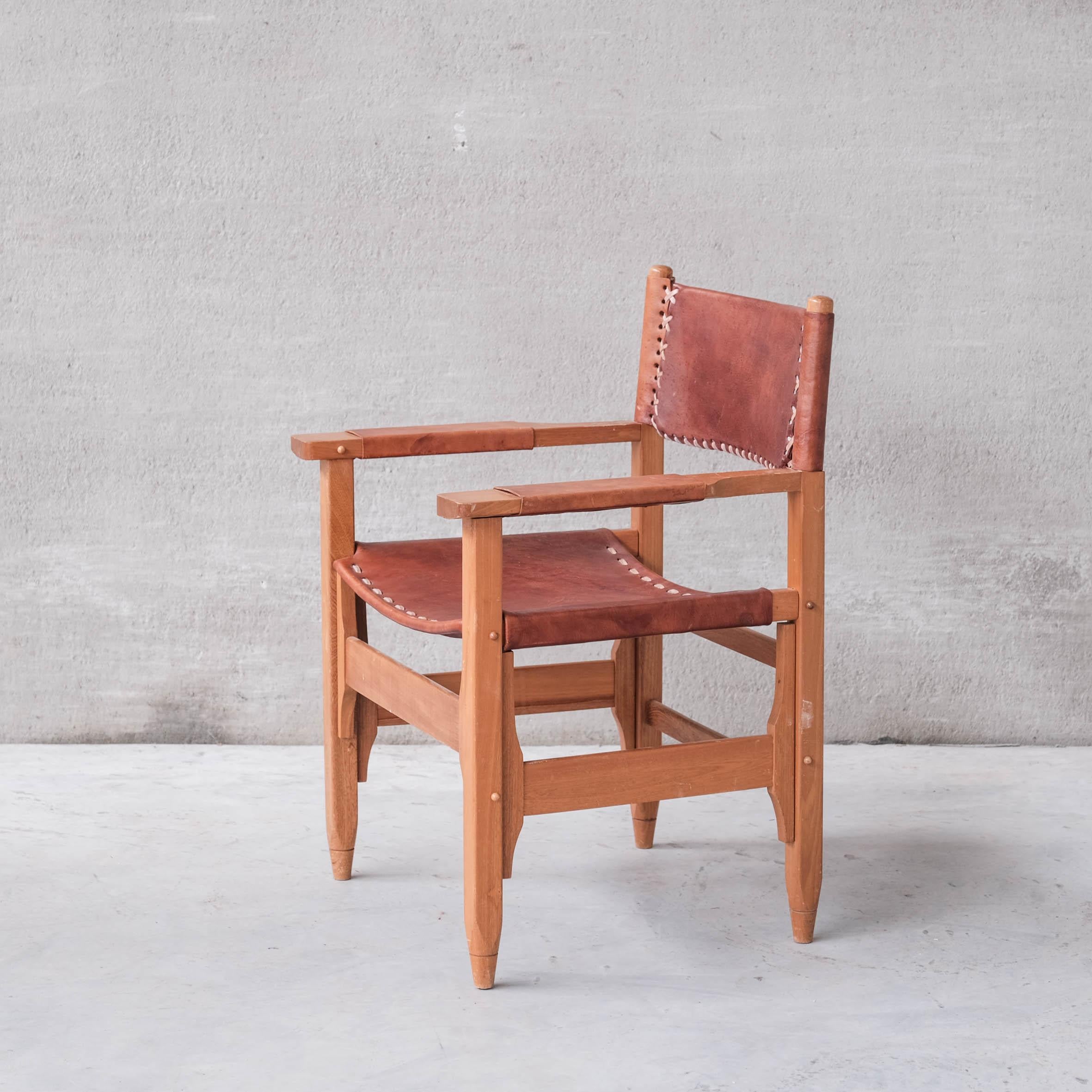 A pair of good quality leather and wood armchairs.

France, c1970s.

Good quality stitched leather.

Good vintage condition, some scuffs and wear commensurate with age.

Price is for the pair.

Location: Belgium Gallery.

Dimensions: 63 W x 52 x 41