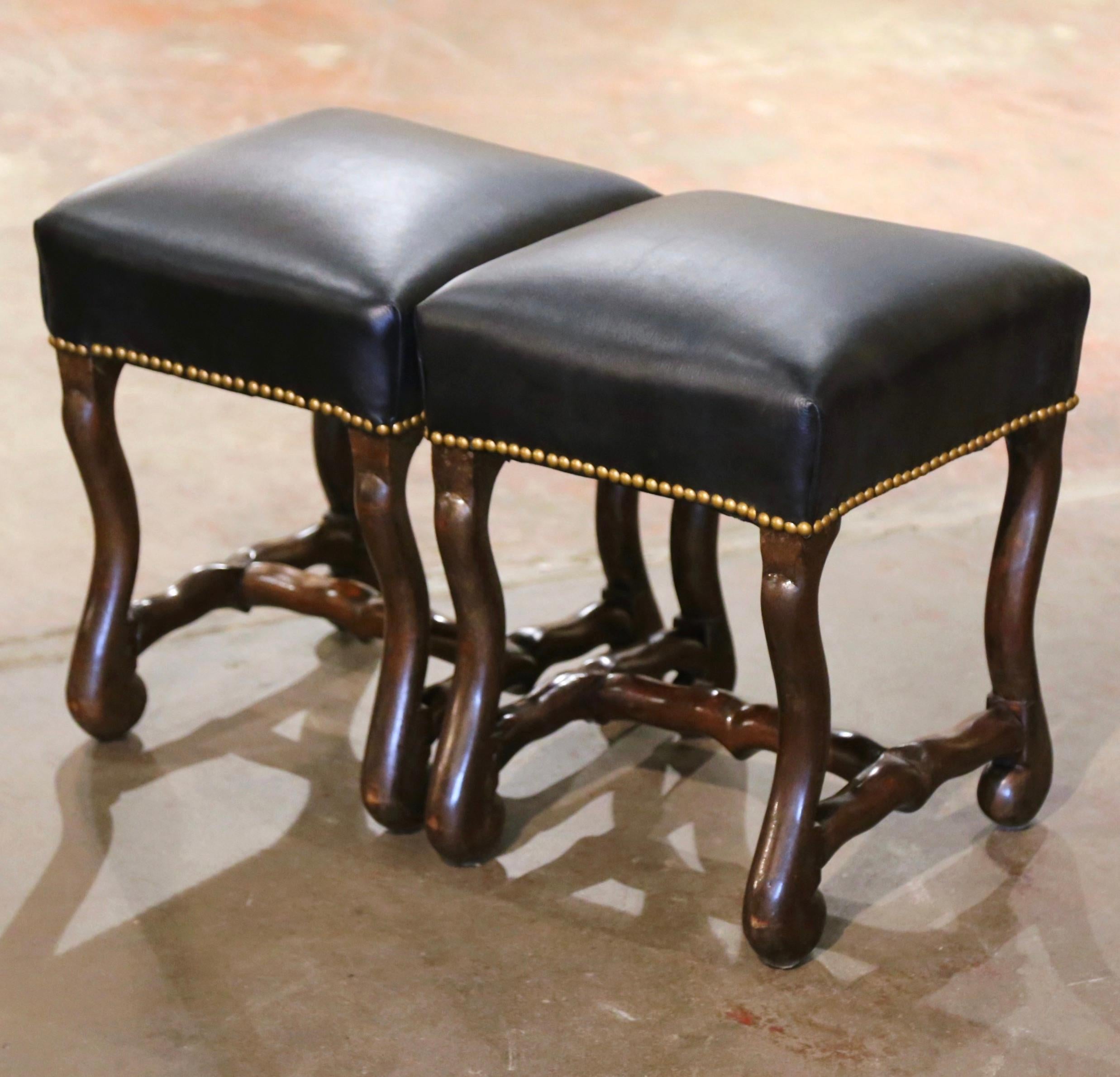 Place these elegant antique stools in a living room or a den for extra seating. Crafted in Southern France circa 1950, and square in shape, each fruitwood stool features hand carved scrolled 