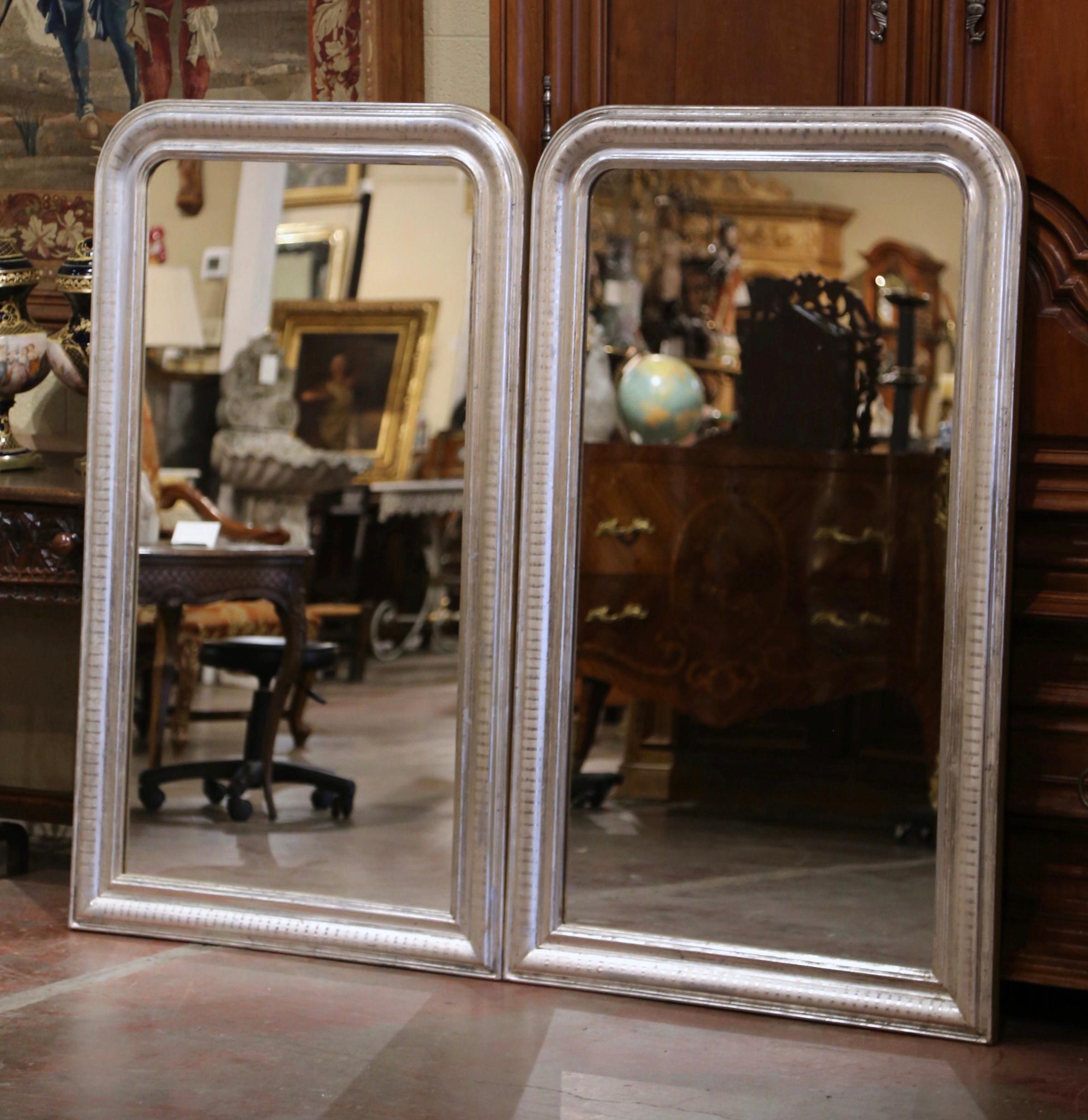Decorate a master bathroom or an entry with this elegant pair of antique mirrors.Crafted in the Burgundy region of France, circa 1960 and rectangular in shape, each large mirror has traditional, timeless lines with round corners at the top; the