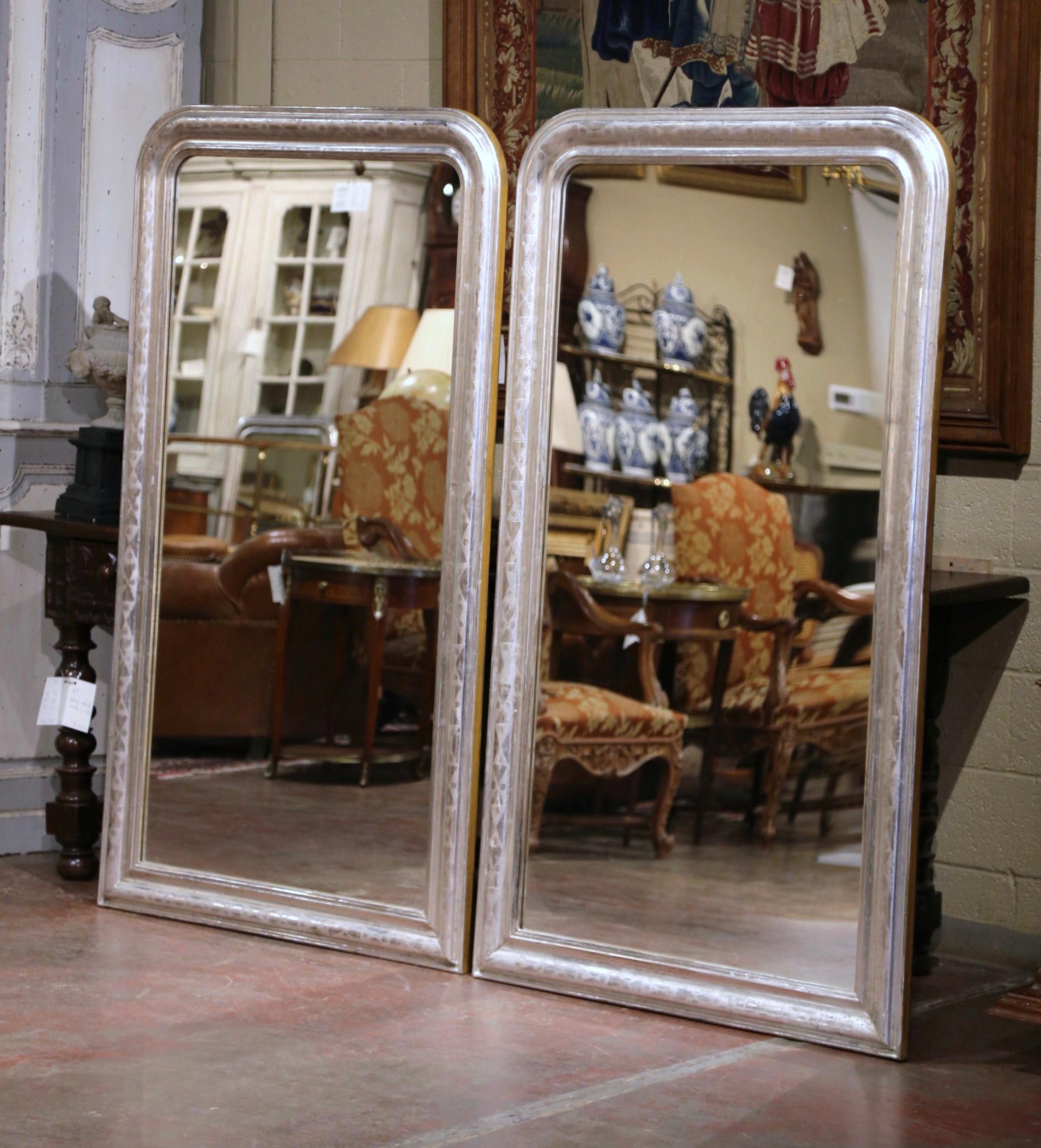 Decorate a master bath or entry with this important pair of antique wall mirrors. Crafted in the Burgundy region of France, circa 1950, and over 5.5 feet in high, the mirrors have traditional, timeless lines with elegant rounded corners. The tall